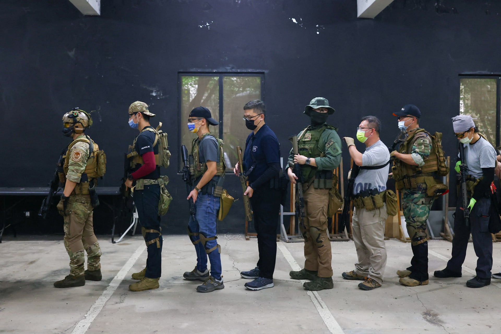 Trainees line up to practice target shooting in New Taipei City, Taiwan, May 21, 2022.