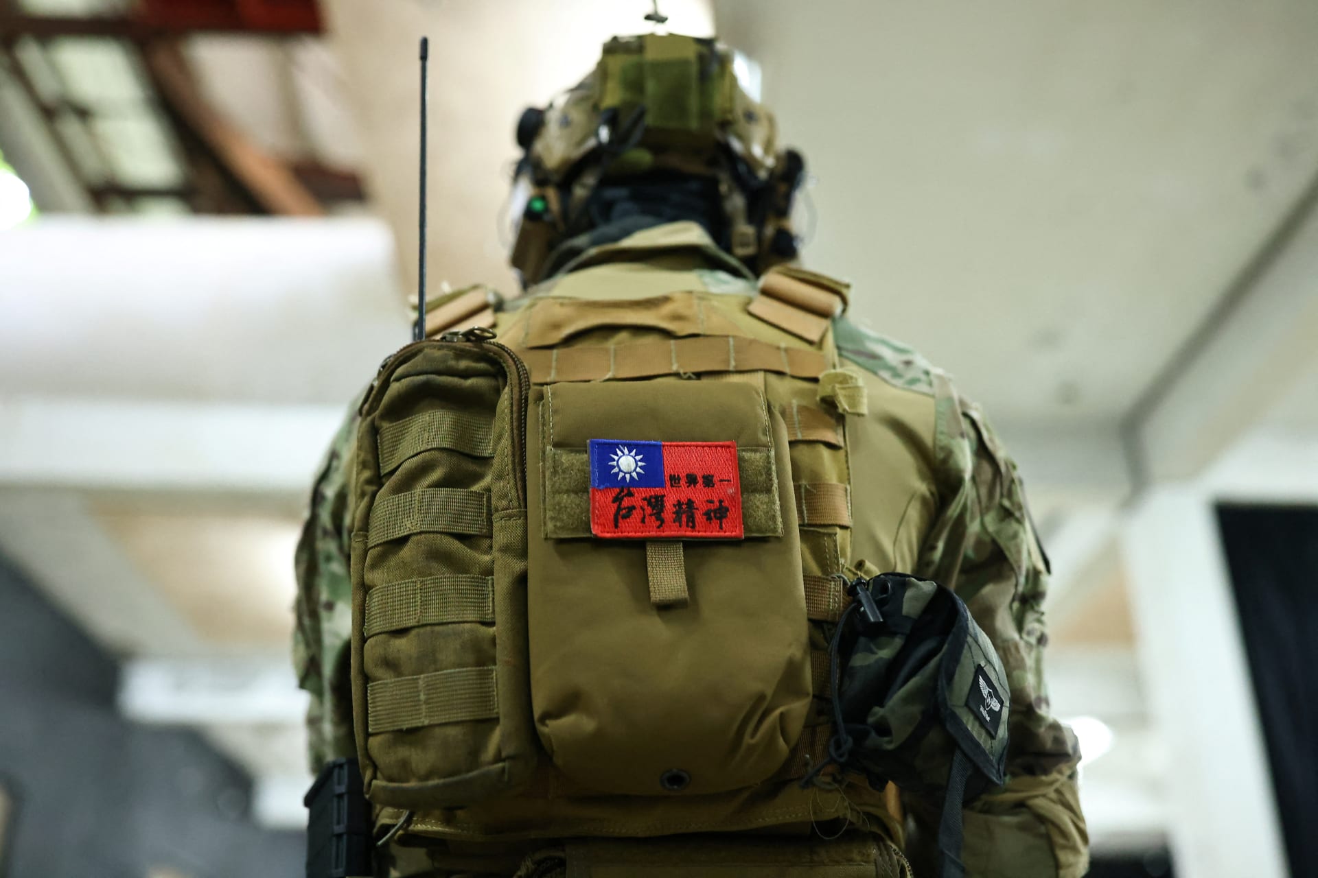 Taiwan spirit, world Number 1” is seen written on the flag of Taiwan on the backpack of a trainee.