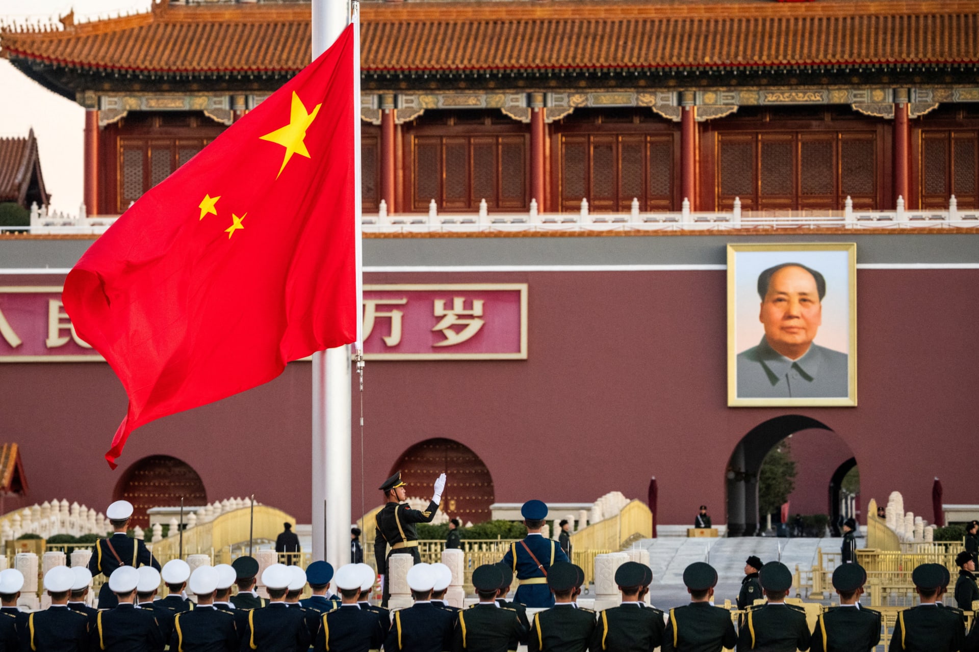 Members of Chinese People's Liberation Army attend a flag-raising ceremony at Tiananmen Square, in Beijing
