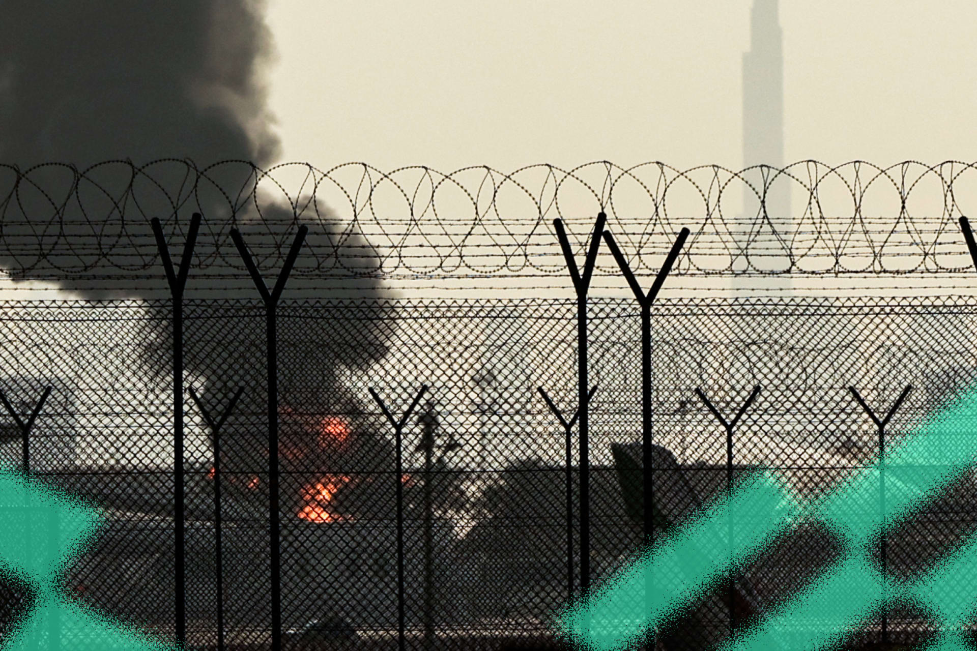 The Dubai skyline is pictured as a smoke plume rises from an ongoing fire near Dubai International Airport on March 16, 2026.