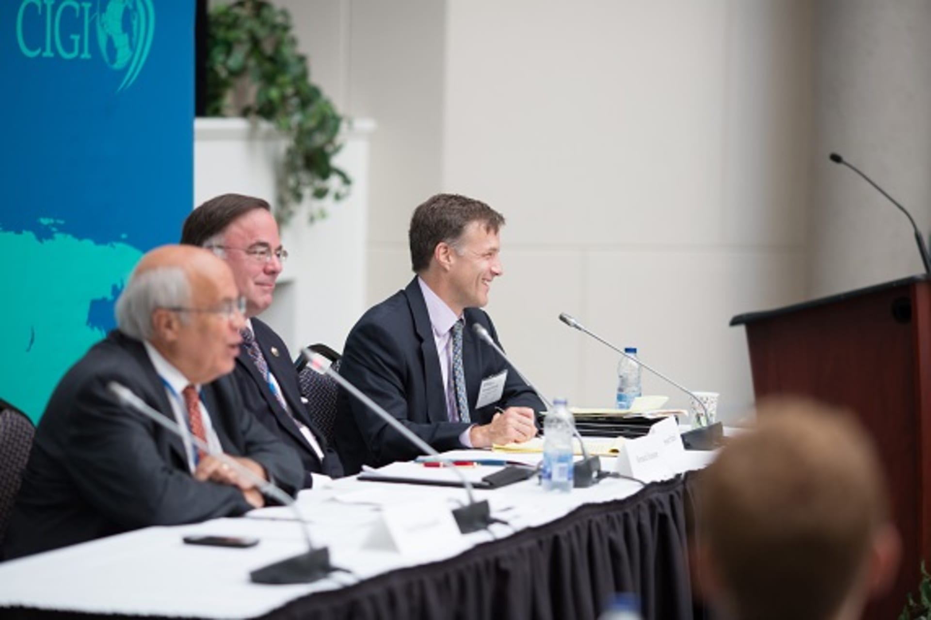 <p>Stewart Patrick (CFR), David Runnalls (CIGI), and Bernard Funston speak during the first session Council of Councils Sixth Regional Conference in Ottawa (Kris Young).</p>