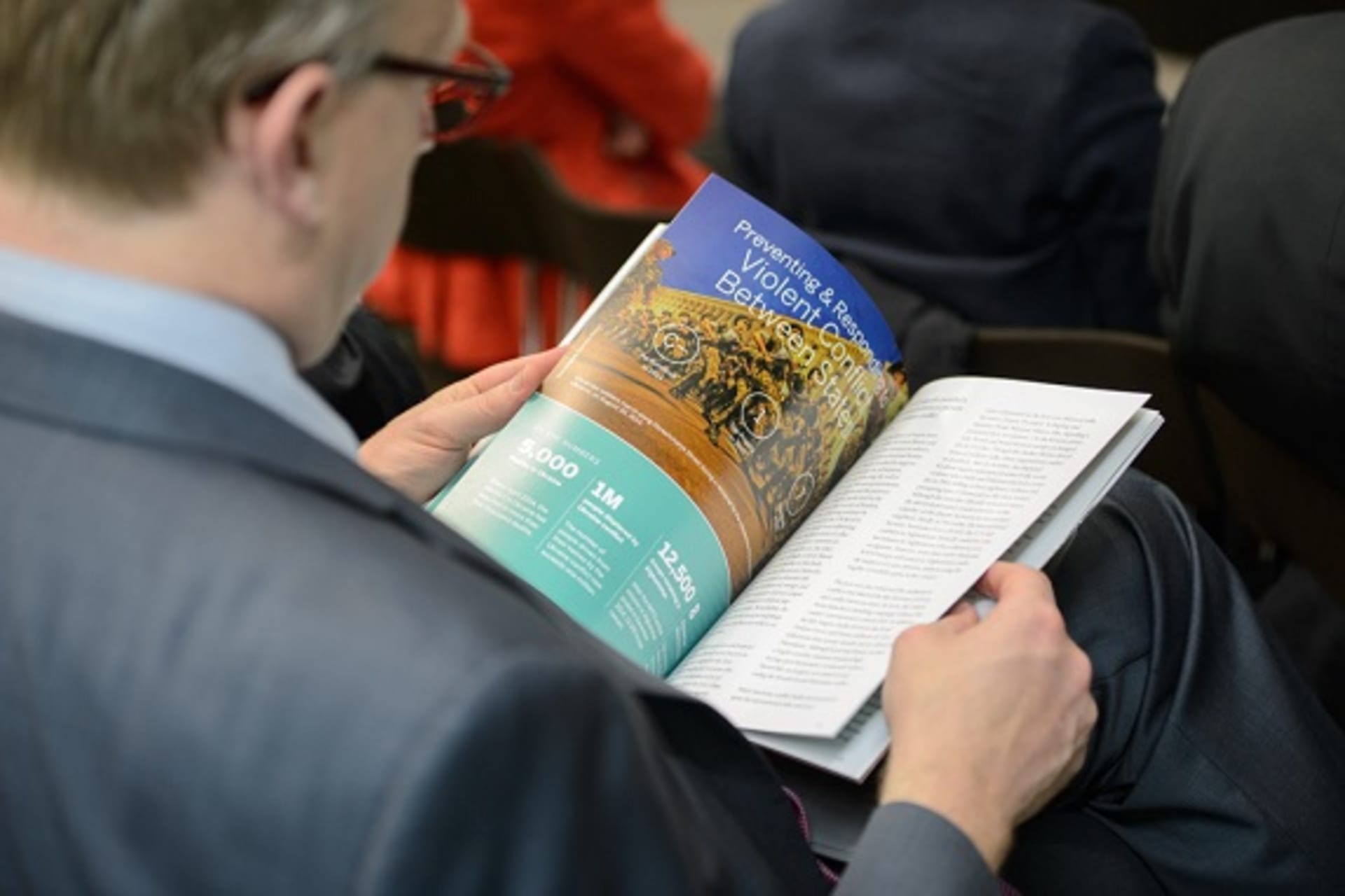 <p>A participant reads the CoC Report Card on International Cooperation during the CoC Fourth Annual Conference (Kaveh Sardari).</p>
