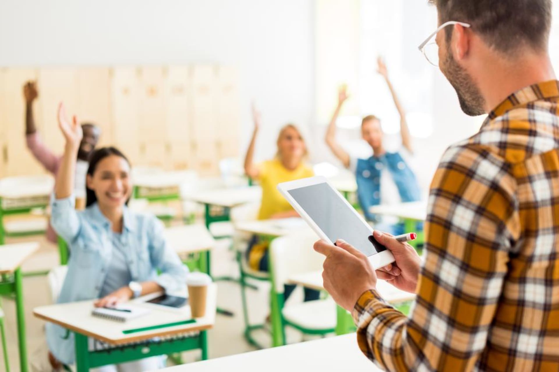 stock-photo-group-young-students-raising-hands-answer-teachers-question-while-standing.jpg
