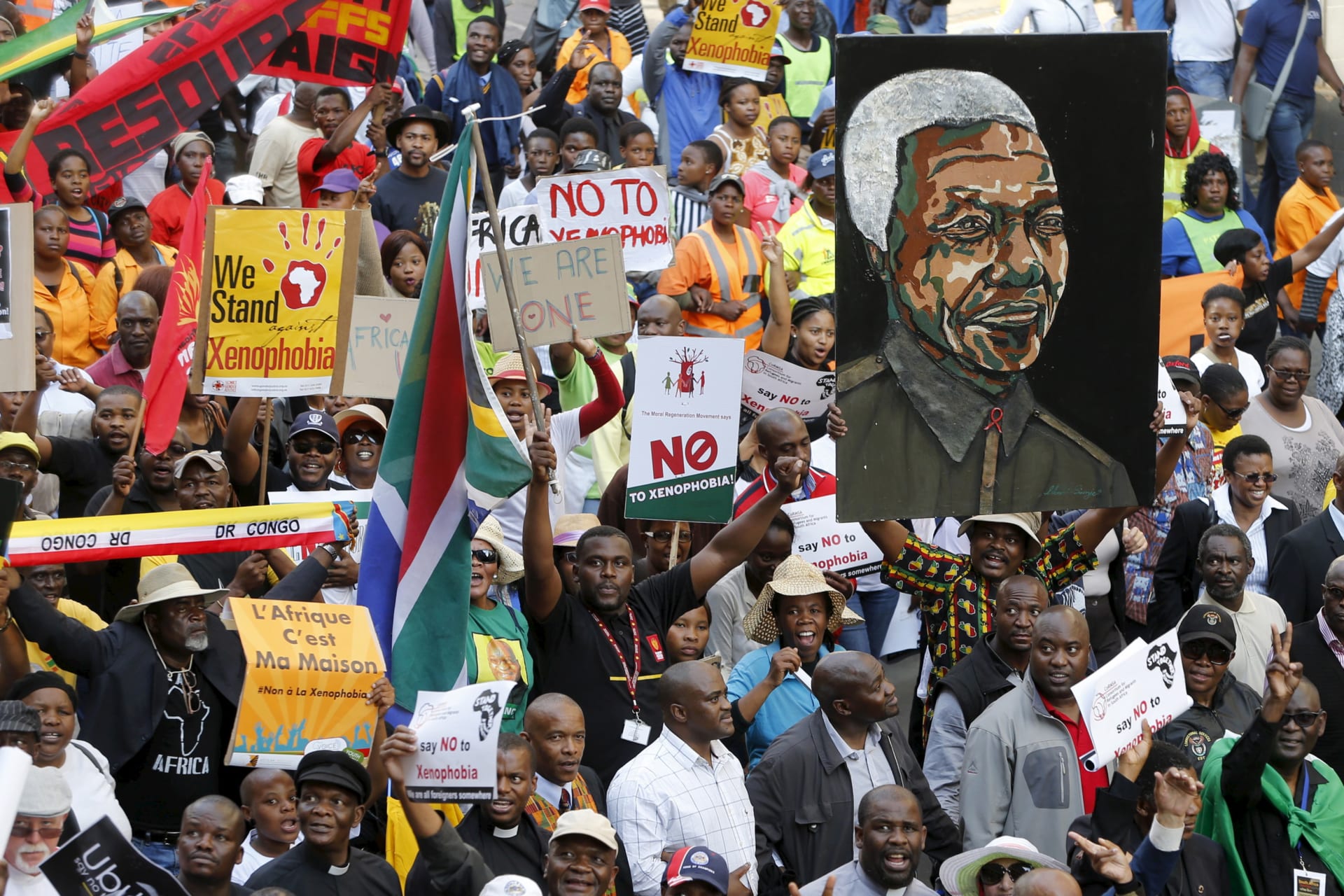 <p>Demonstrators carry placards during a march against xenophobia in downtown Johannesburg, South Africa, on April 23, 2015.</p>
