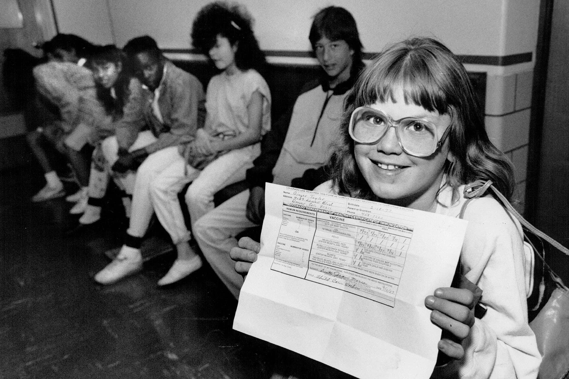 <p>A middle school student shows proof of immunization against measles after returning to school in Denver, Colorado, on April 27, 1989.</p>
