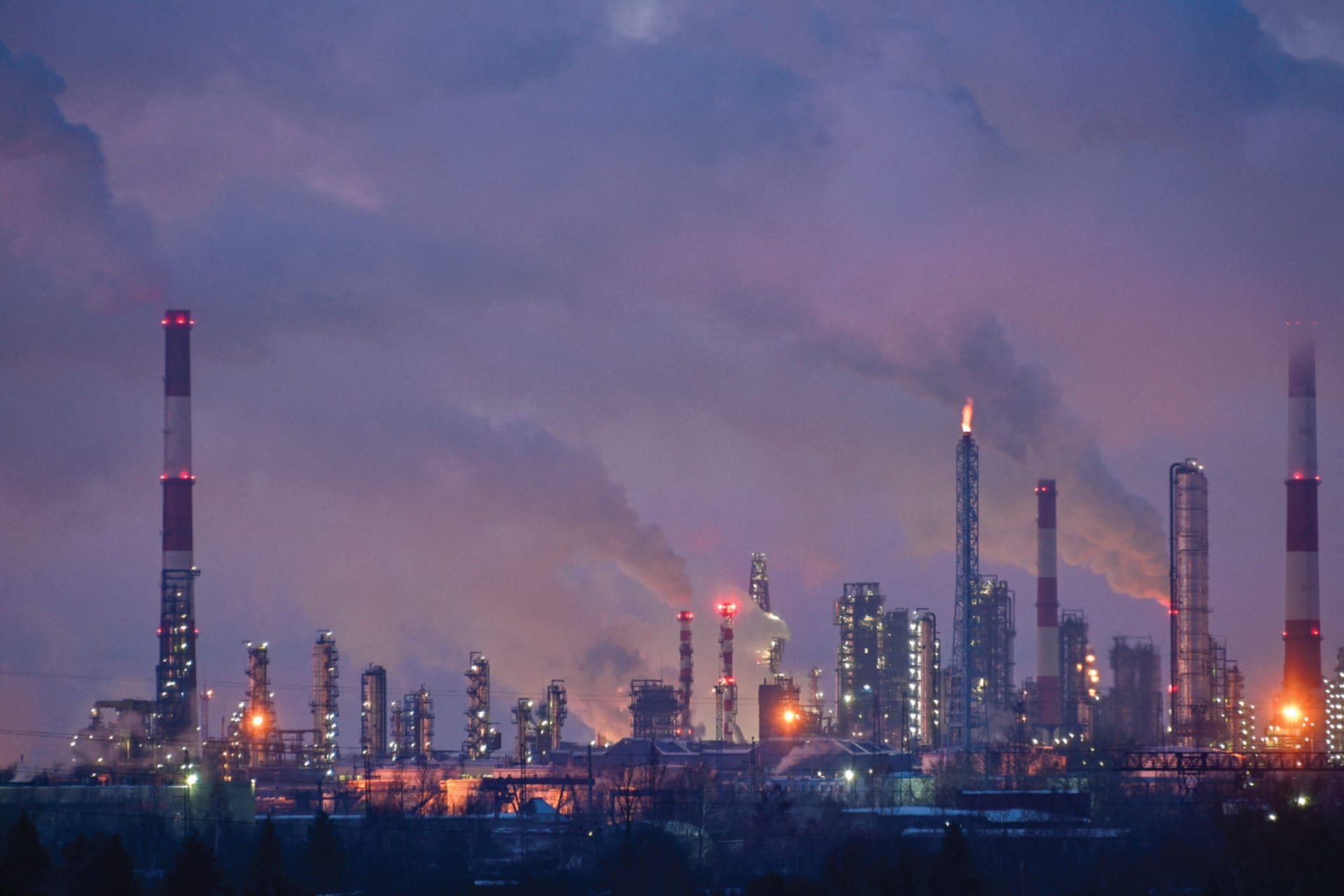 Gas and steam rise out of smokestacks at an oil refinery in Omsk, Russia