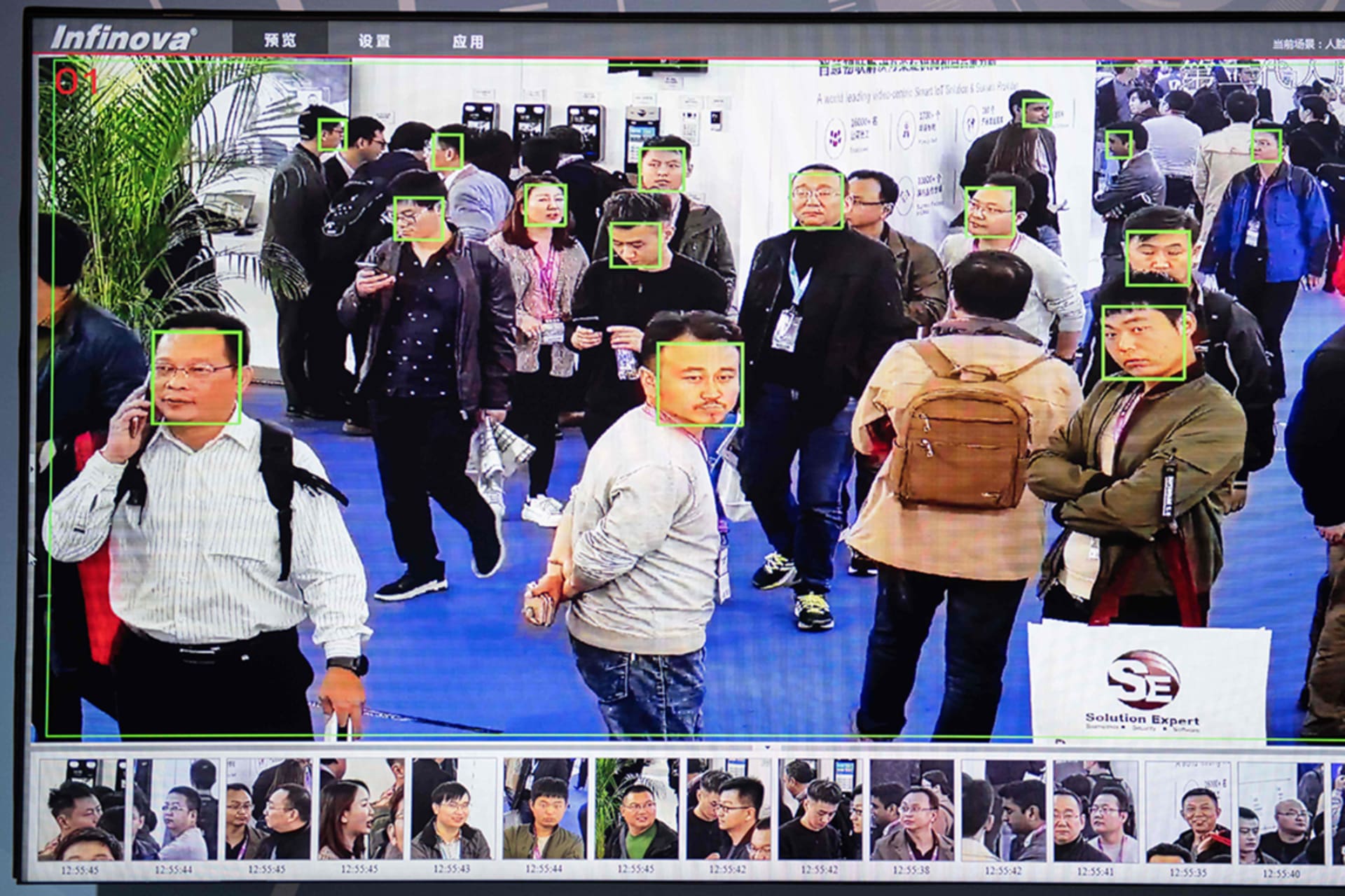 A screen shows visitors being filmed by AI (artificial intelligence) security cameras with facial recognition technology at the 14th China International Exhibition on Public Safety and Security at the China International Exhibition Center in Beijing.