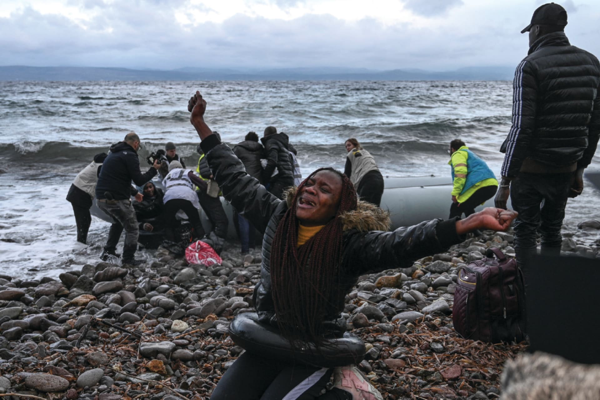 A woman reacts after a warship rescued her during a migrant sea crossing from Gambia and the Republic of Congo; the vessel landed on Lesbos Island on February 29, 2020.