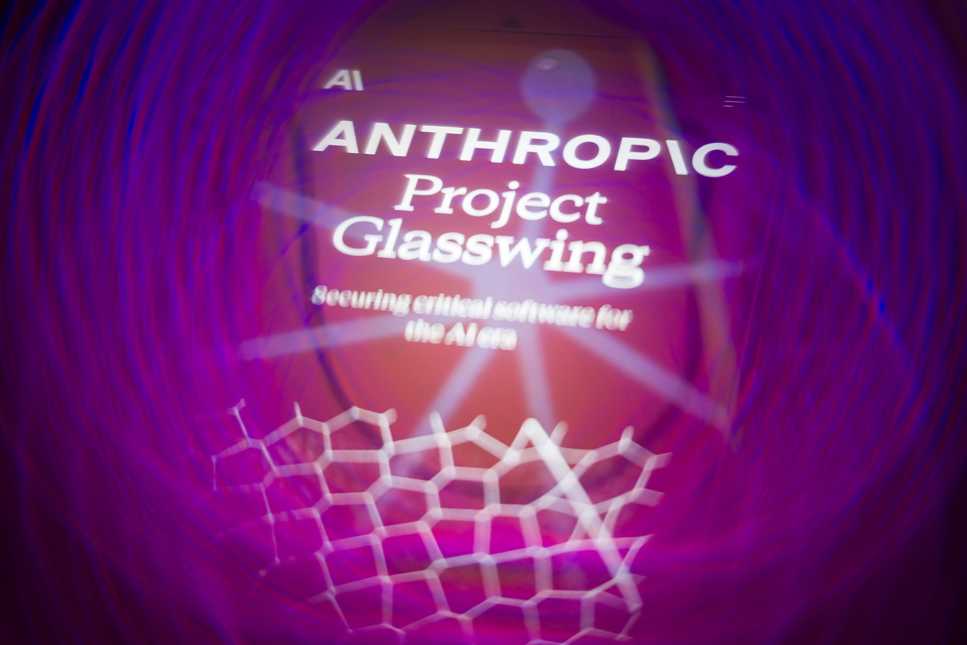 Anthropic's Project Glasswing website is displayed on a smartphone screen with purple graphics.