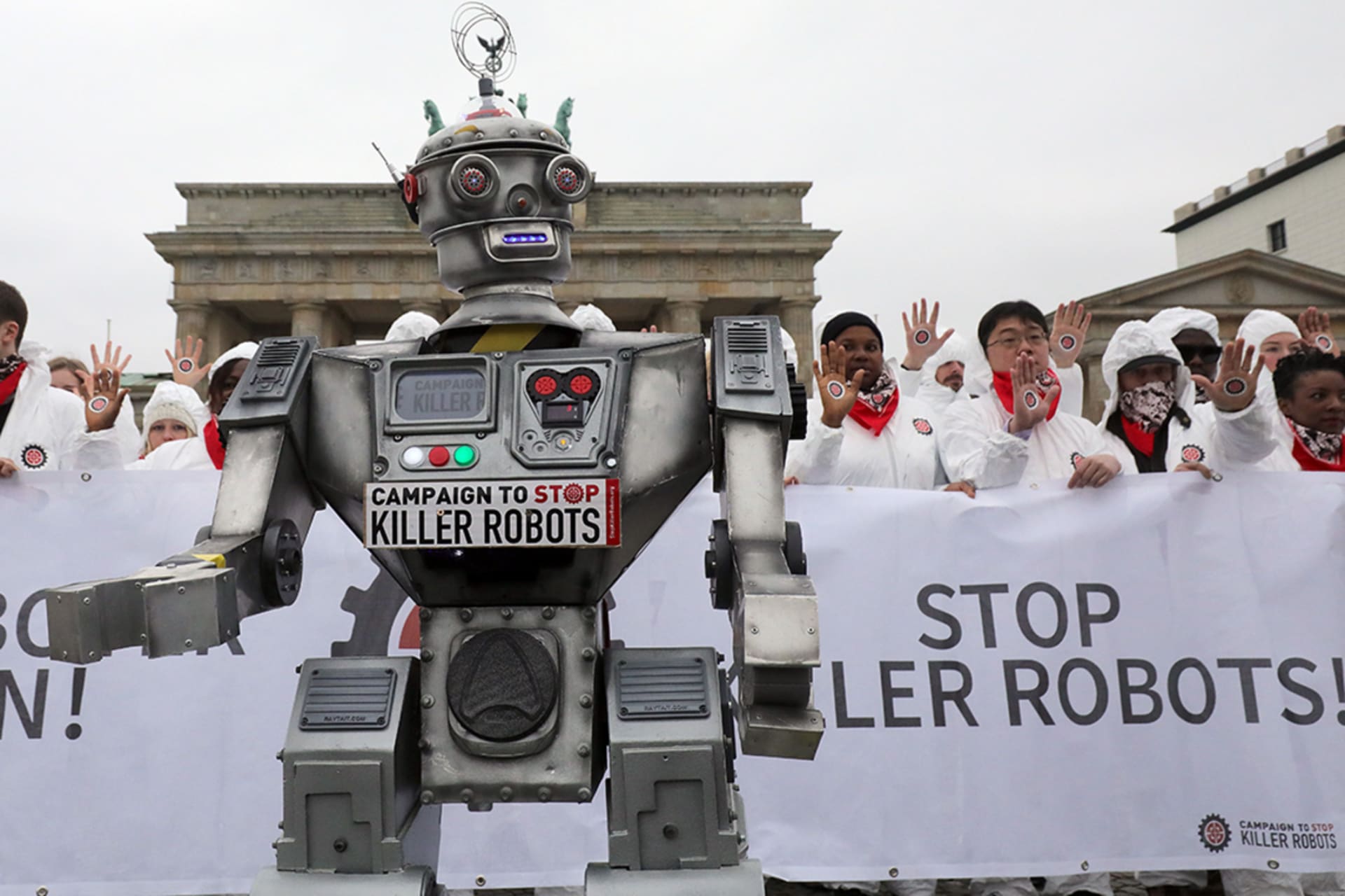 People take part in a demonstration as part of the "Stop Killer Robots" campaign organized by German NGO "Facing Finance" to ban what they call killer robots on March 21, 2019 in front of the Brandenburg Gate in Berlin.