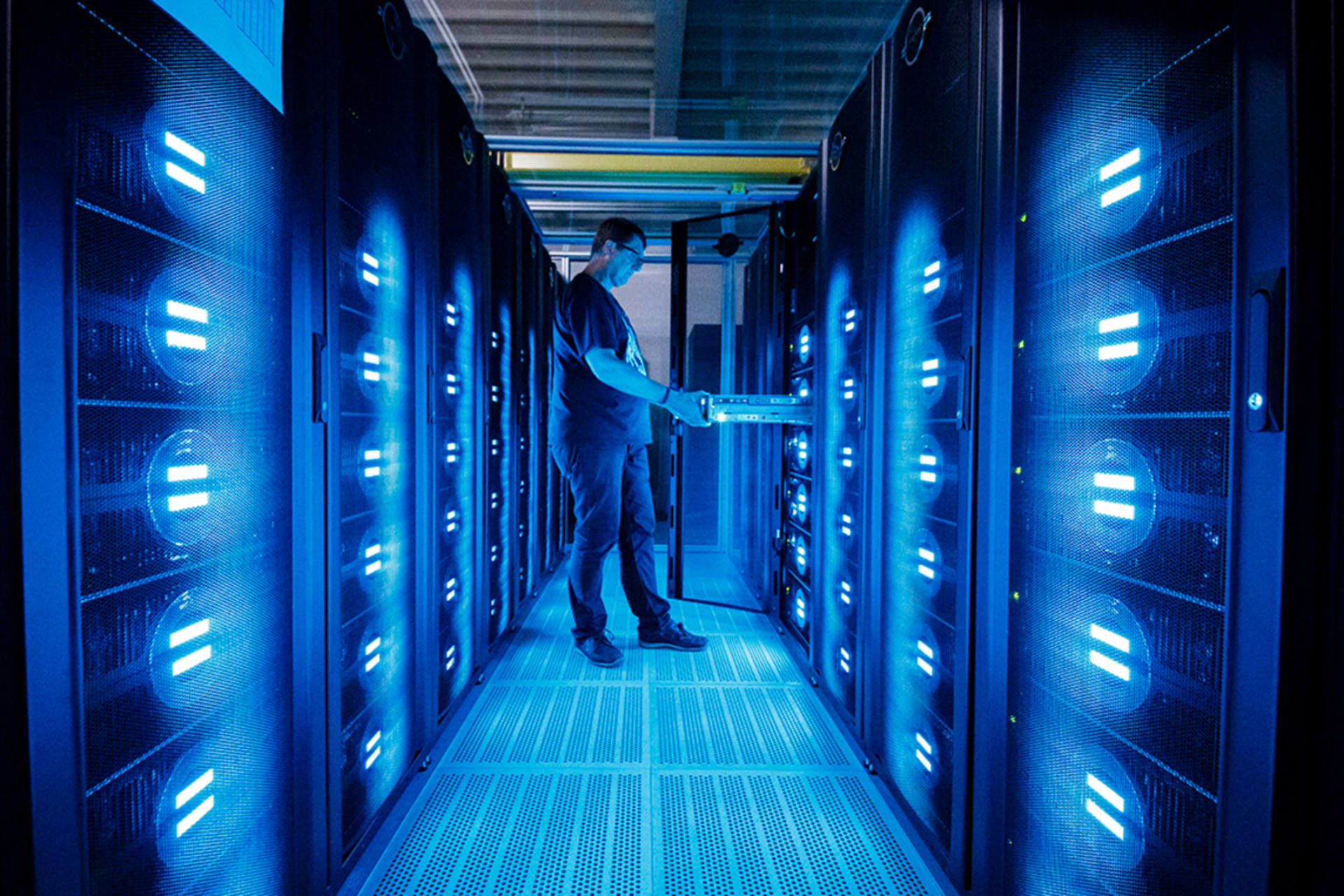 An employee of the German Climate Computing Center (DKRZ, or Deutsches Klimarechenzentrum) poses next to the "Mistral" supercomputer on June 7, 2017 in Hamburg, Germany.