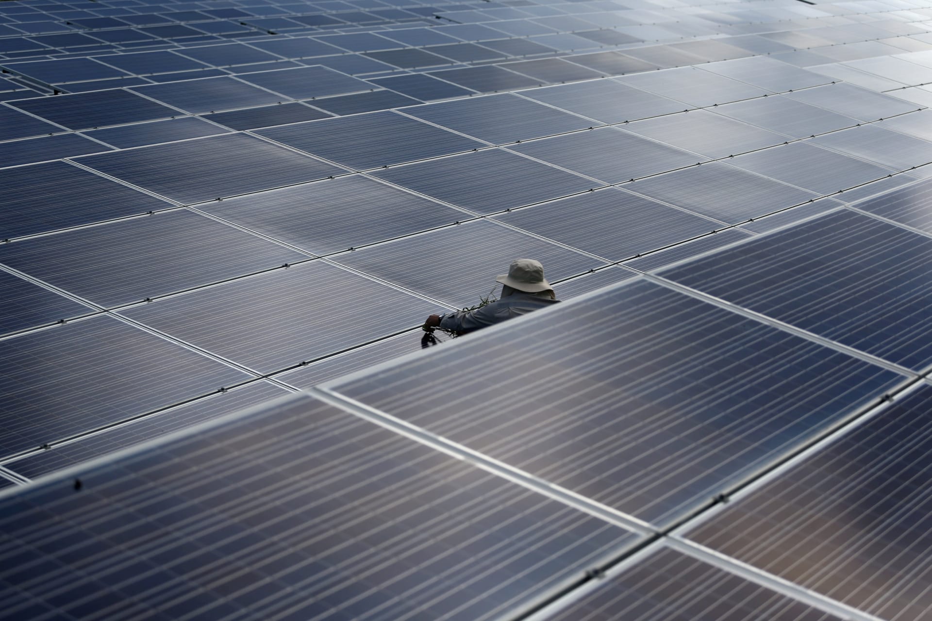 A worker works at a solar power plant by Superblock, Southeast Asia's biggest producer of solar power in Phetchaburi province