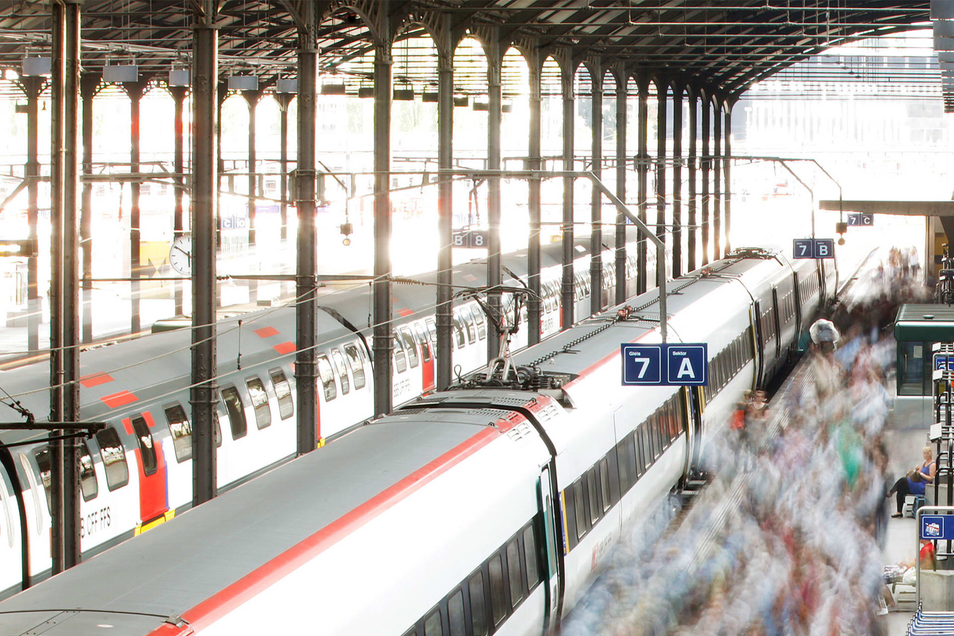 A long exposure picture shows blurred out commuters walking on a Swiss Federal Railways platform at the main station in Lucerne on August 7, 2012.