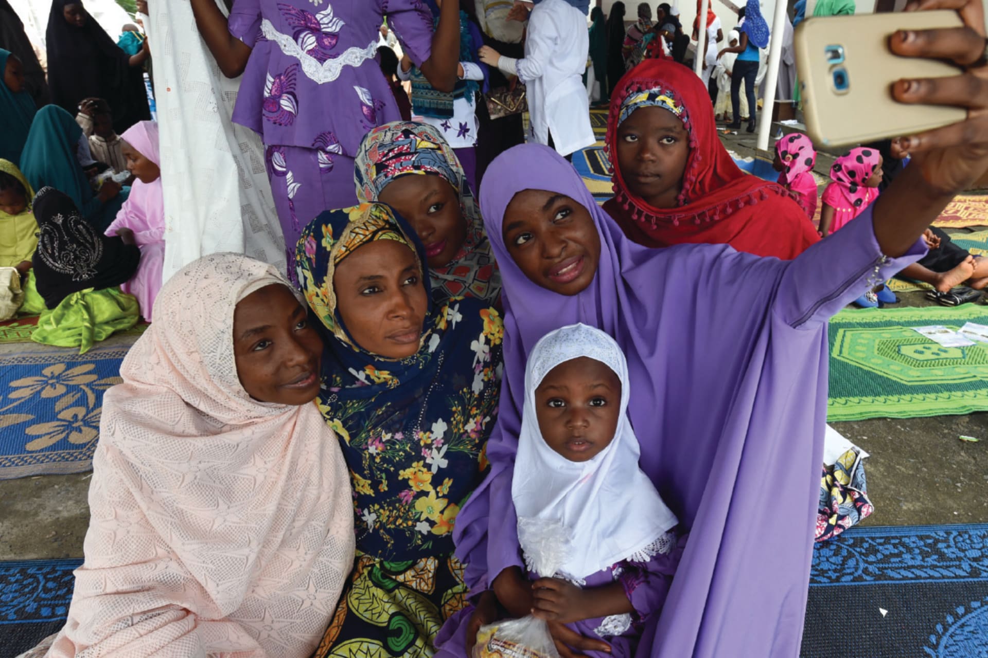 A group of young Muslim girls take a selfie as they attend the Eid al-Fitr prays at the Syrian Mosque, in Lagos, Nigeria on June 25, 2017.