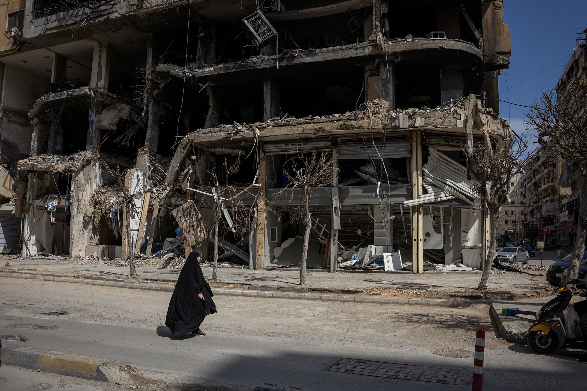 <p>A woman walks past damaged buildings amid a ten-day ceasefire between Lebanon and Israel, in the southern suburbs of Beirut, Lebanon, April 20, 2026. </p>
