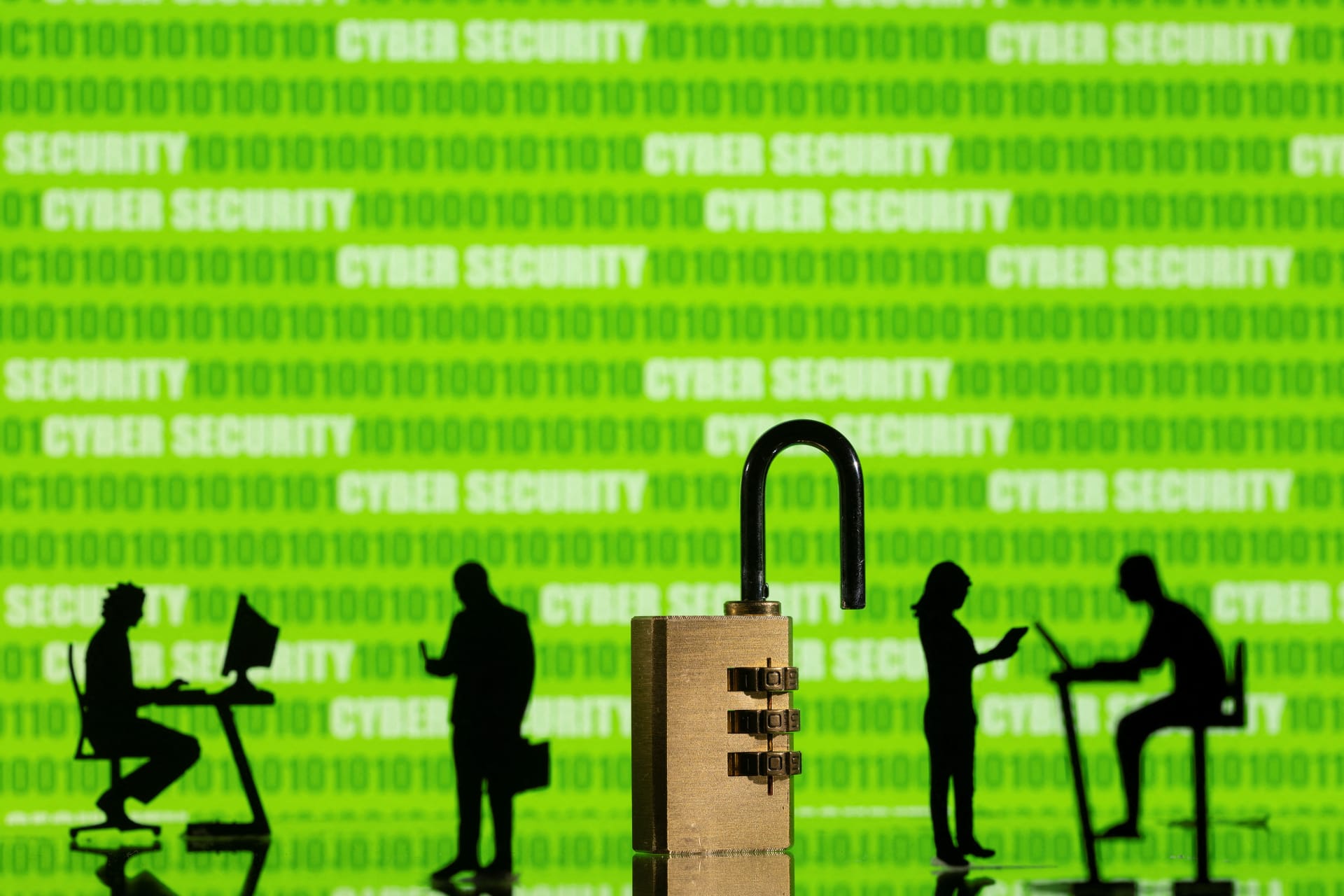 Illustration shows displayed "cyber security" words and binary code