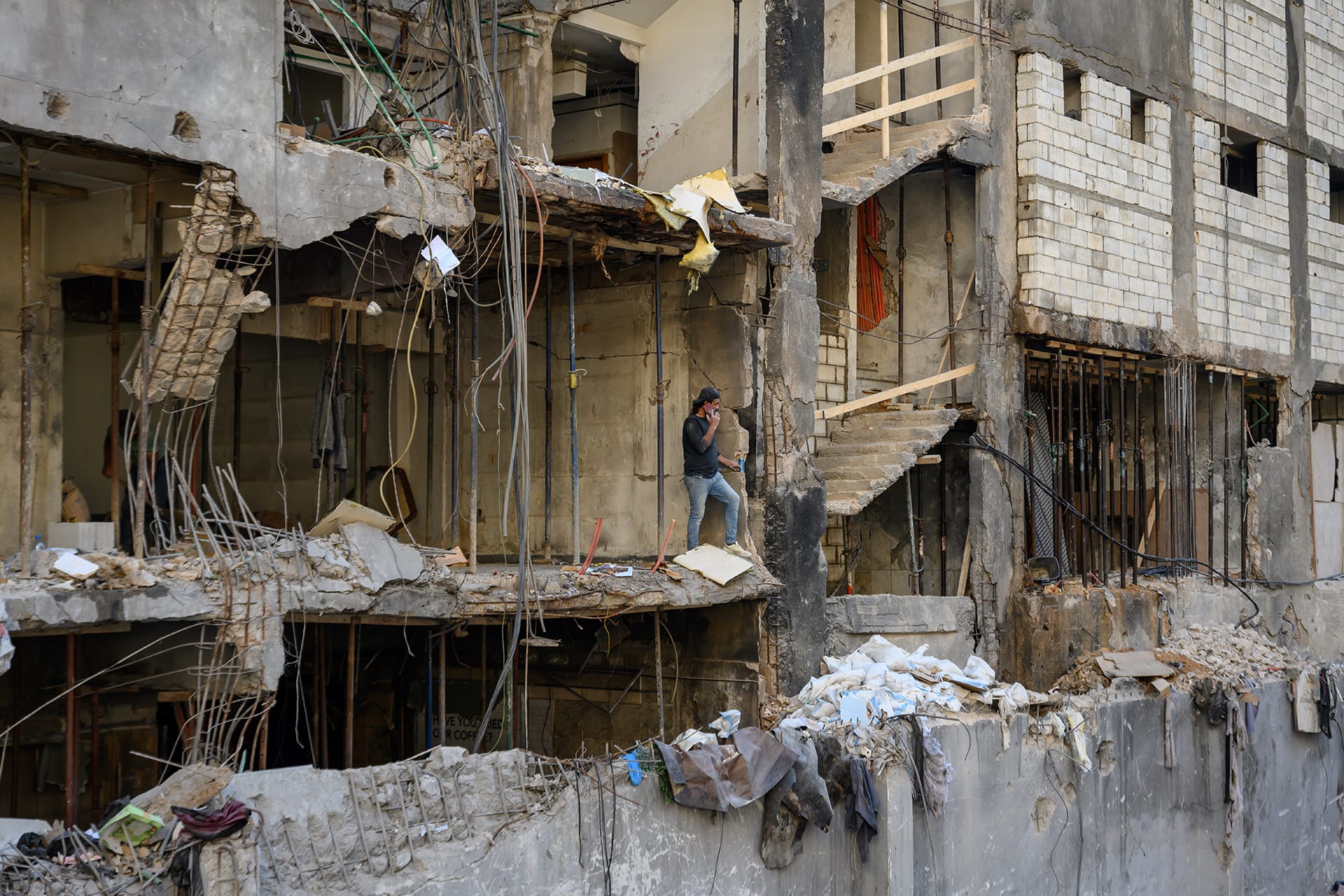 <p>Workers clear debris and collect scrap metal from a building destroyed by Israeli airstrikes in the Corniche al-Masraa neighborhood on April 23, 2026, in Beirut, Lebanon.</p>

