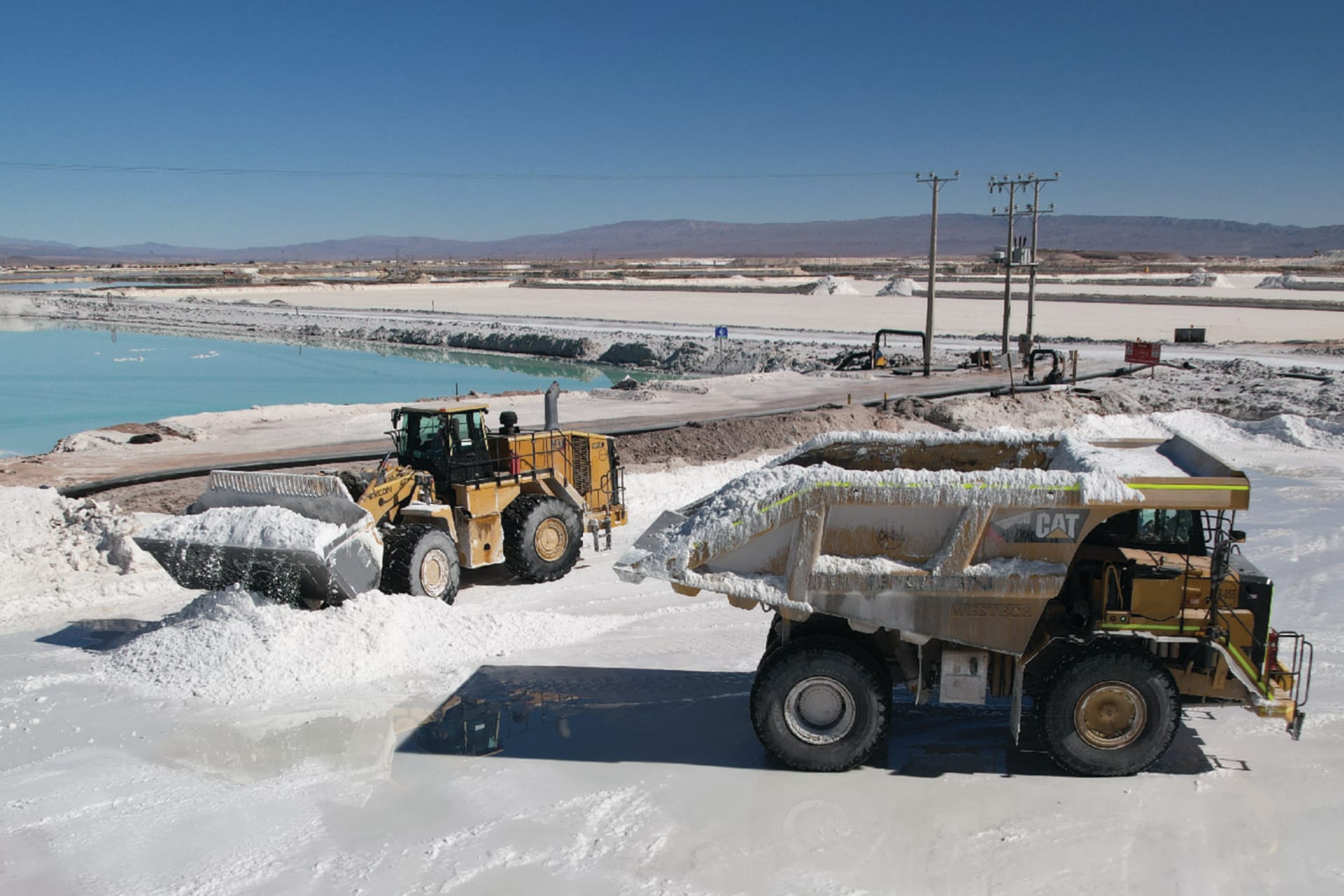 Mining trucks load lithium sulfate in the Atacama Desert, Chile, on July 29, 2024.