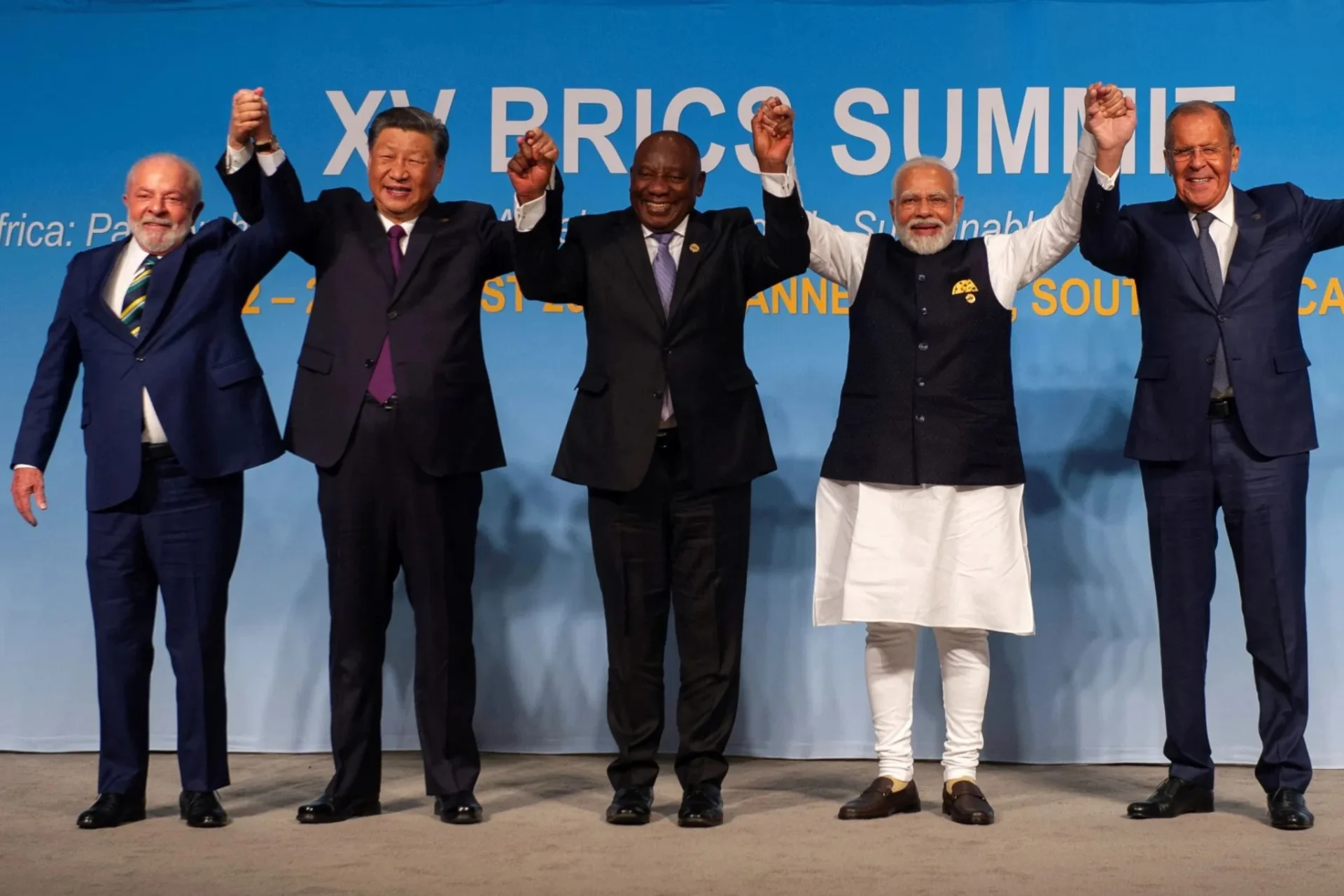 BRICS leaders holding hands high