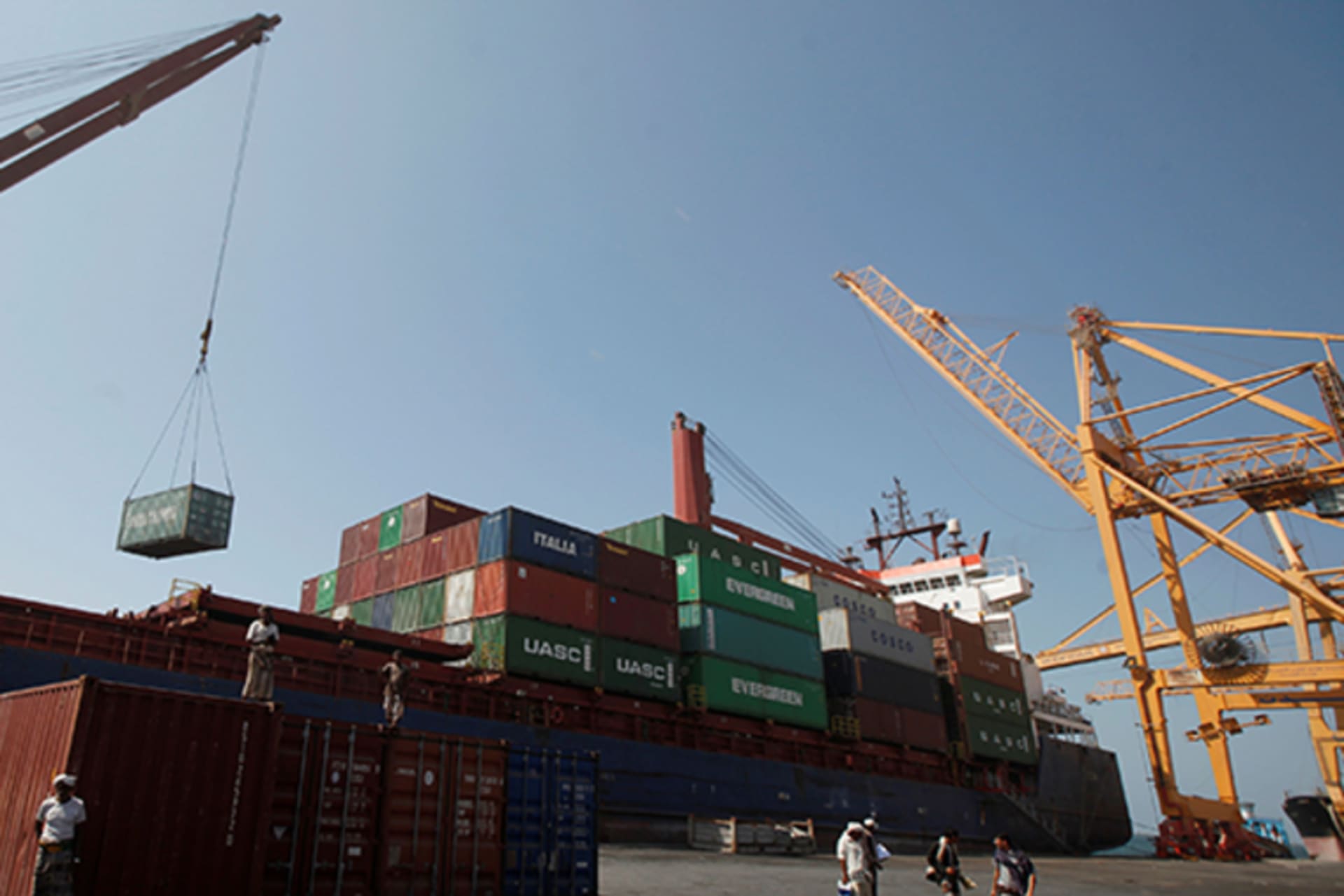 A ship uses its crane to unload containers at a terminal at the Red Sea port of Hodeidah, Yemen on November 16, 2016.