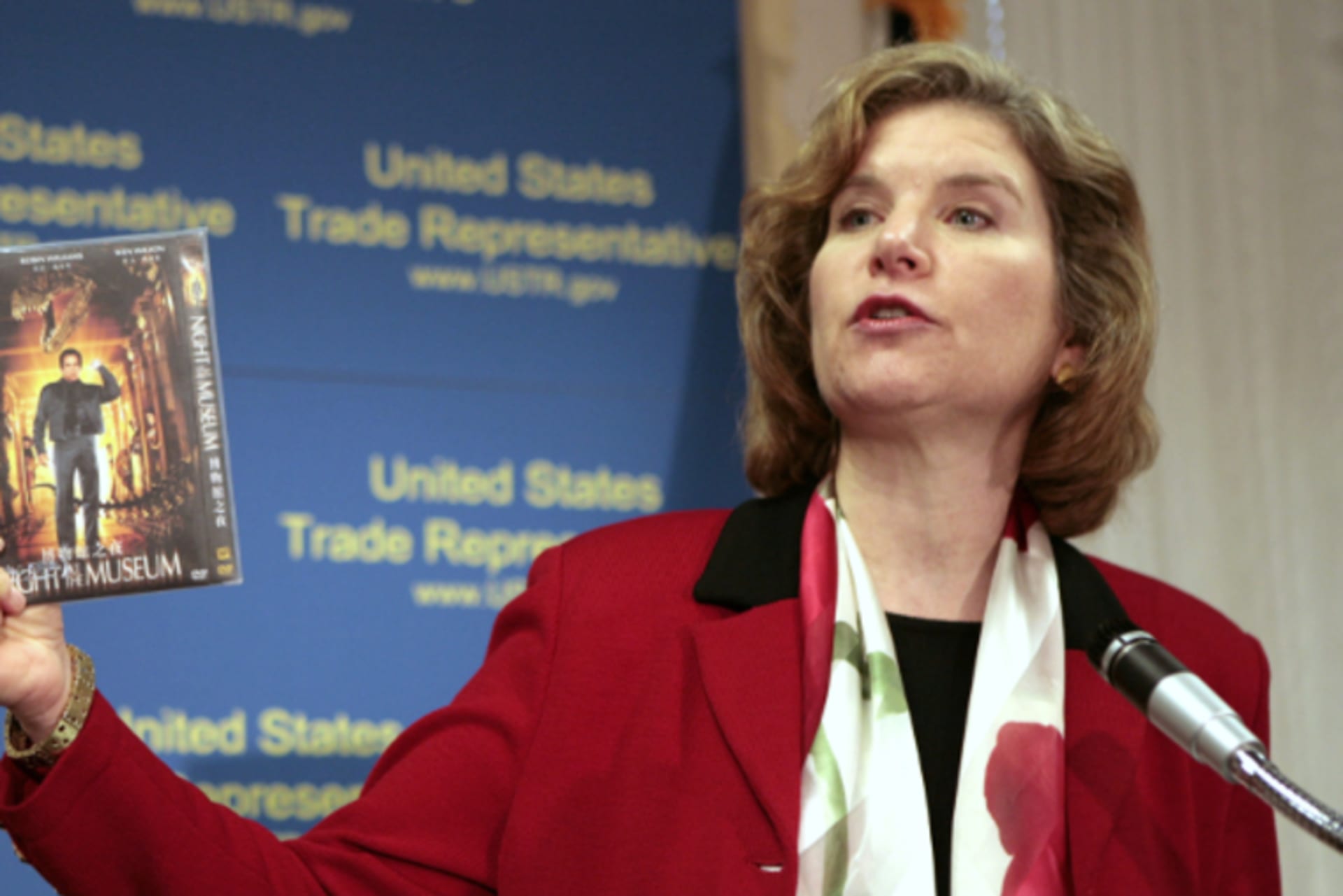 U.S. Trade Representative Susan Schwab holds up a pirated DVD as she talks about two WTO cases against China during a news conference in Washington, DC, on April 9, 2007.