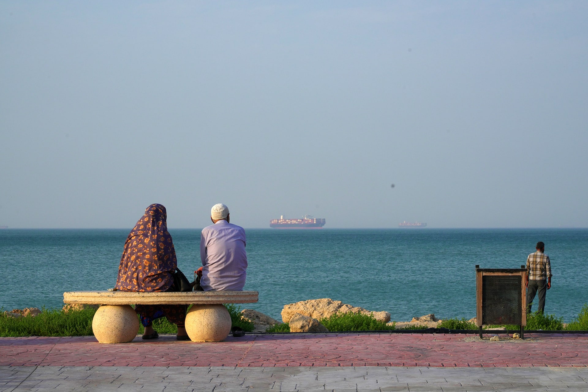 <p>People sit at the shoreline as boats navigate the sea on April 28, 2026, on Qeshm Island, Iran, in the Strait of Hormuz. </p>
