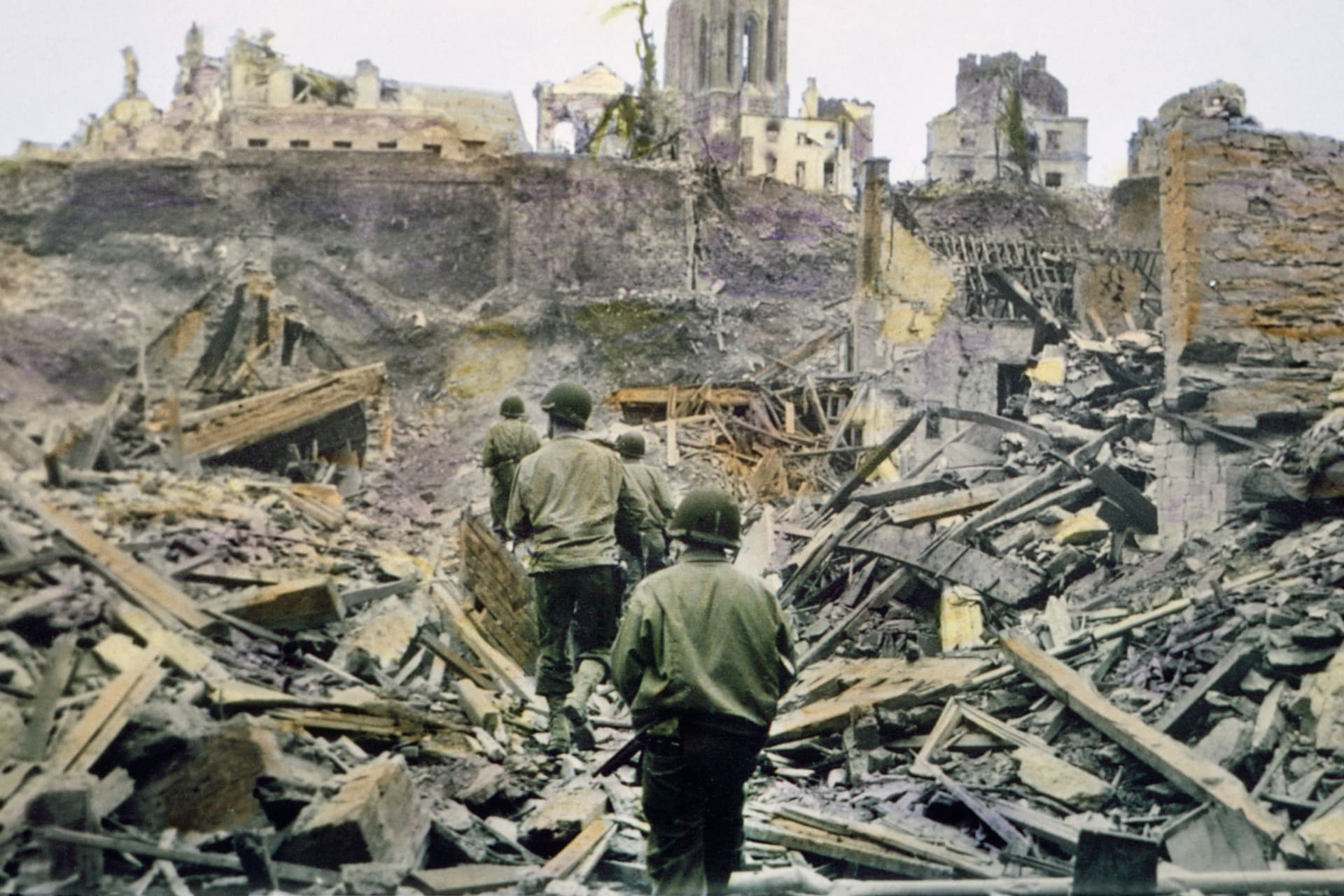 An American infantry patrol walks through the ruins of the French town of Saint-Lo, after it was captured from Germans in the Battle of Normandy in July 1944.