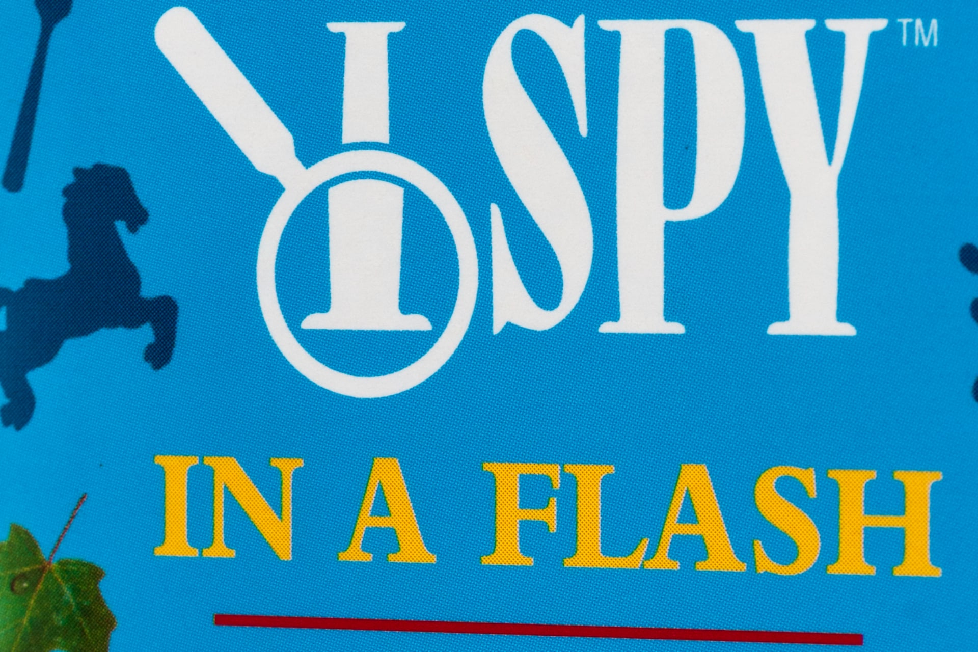 An "I Spy in a Flash" card game box from the "Scholastic" brand owned by Scholastic Inc.