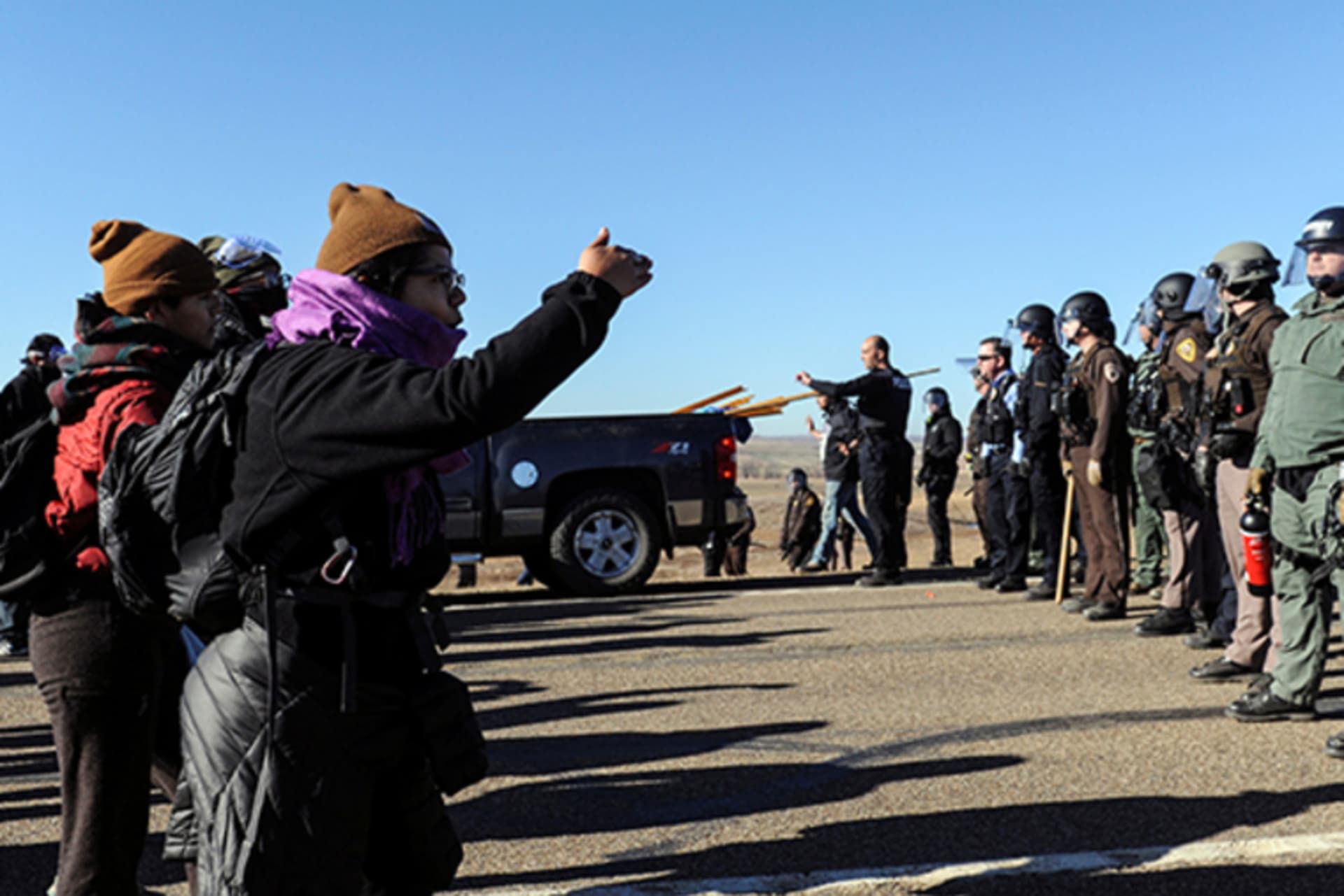 Police block the highway from protesters next to the pipeline route during a protest against the Dakota Access pipeline near the Standing Rock Indian Reservation in St. Anthony, North Dakota on November 11, 2016.