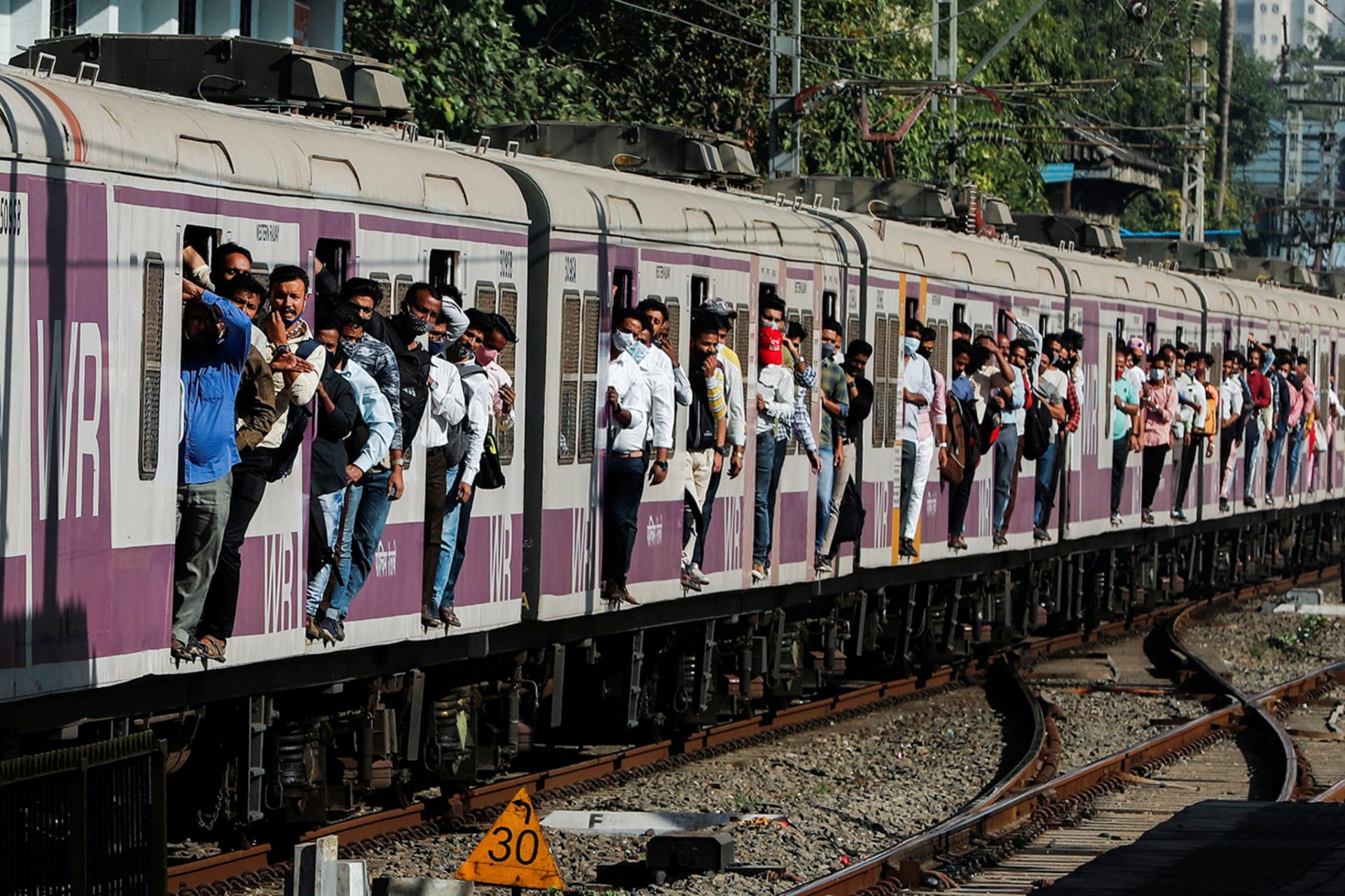 Commuters travel in a crowded train in Mumbai.