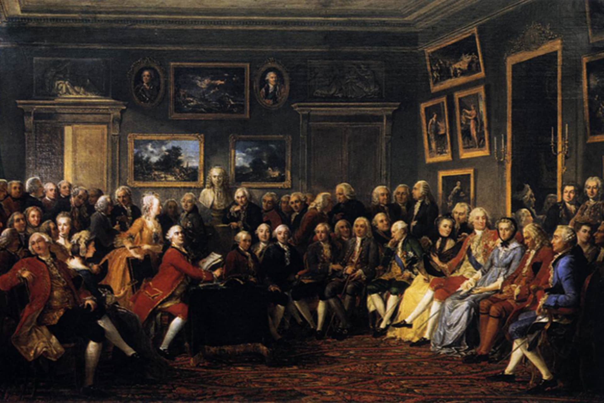 A painting depicts Enlightenment thinkers — including Jean-Jacques Rousseau, Montesquieu, and a bust of Voltaire — in a drawing room, gathered for a reading of Voltaire’s play “L’Orphelin de la Chine” in 1755.