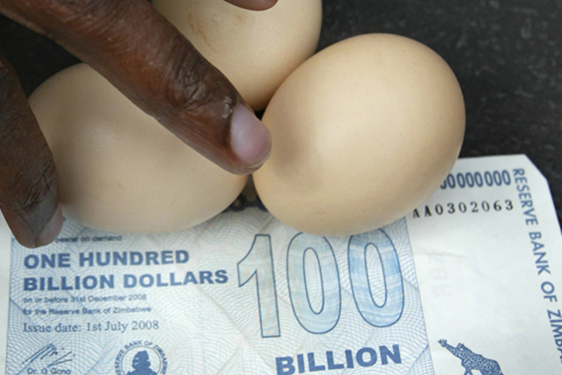 A vendor arranges eggs on a 100 billion Zimbabwean dollar note in Harare, on July 22, 2008. At the time, an egg cost ZW$35 billion.