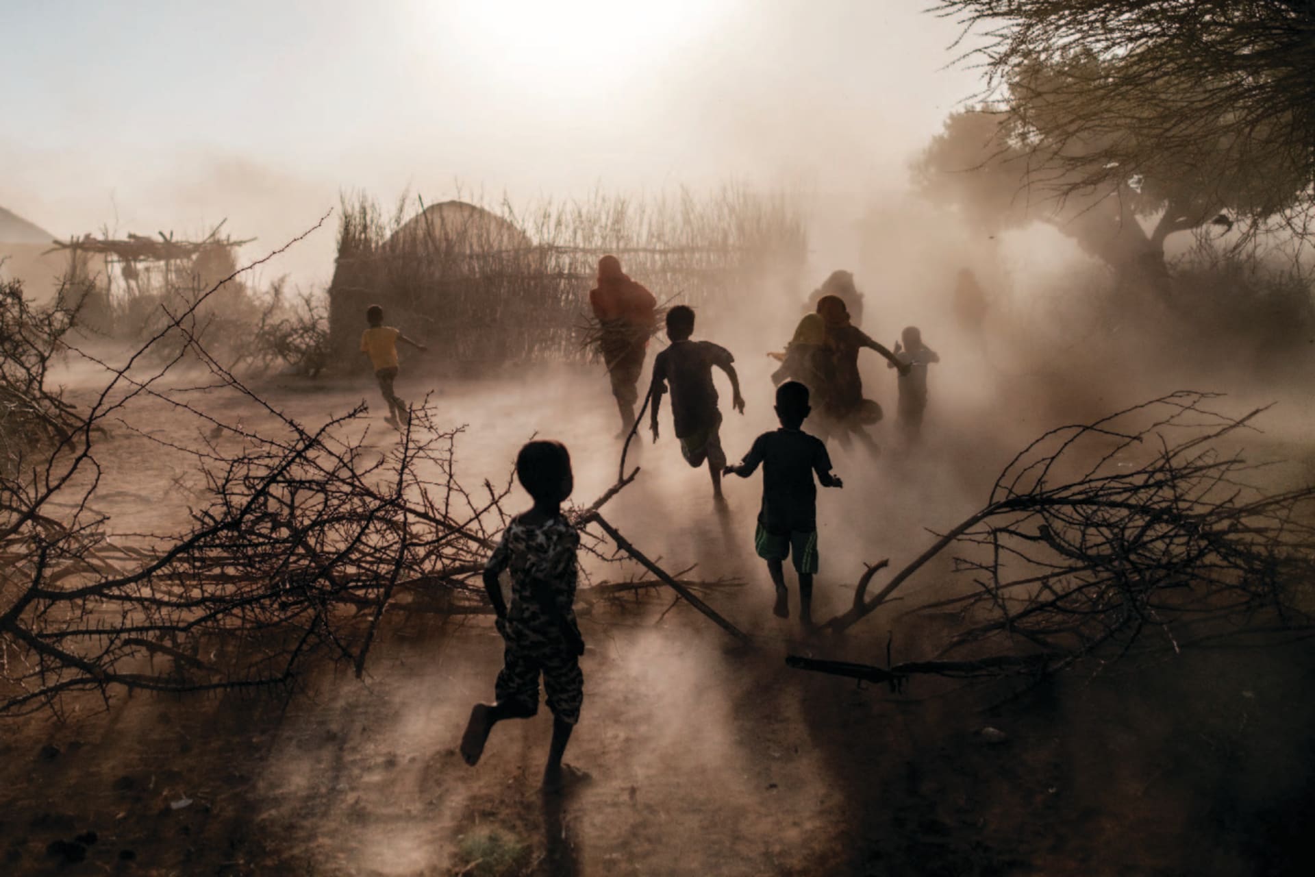 Children and women run through the village of El Gel, Ethiopia on January 12, 2023. The Horn of Africa region is experiencing extreme drought, conflict, and food insecurity.
