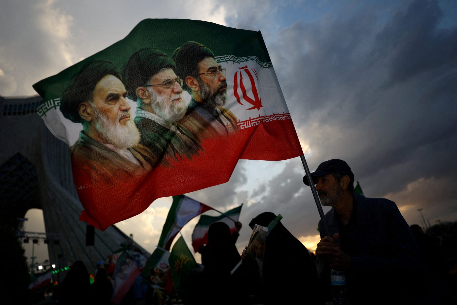 FILE PHOTO: A man holds a flag during a rally in Tehran
