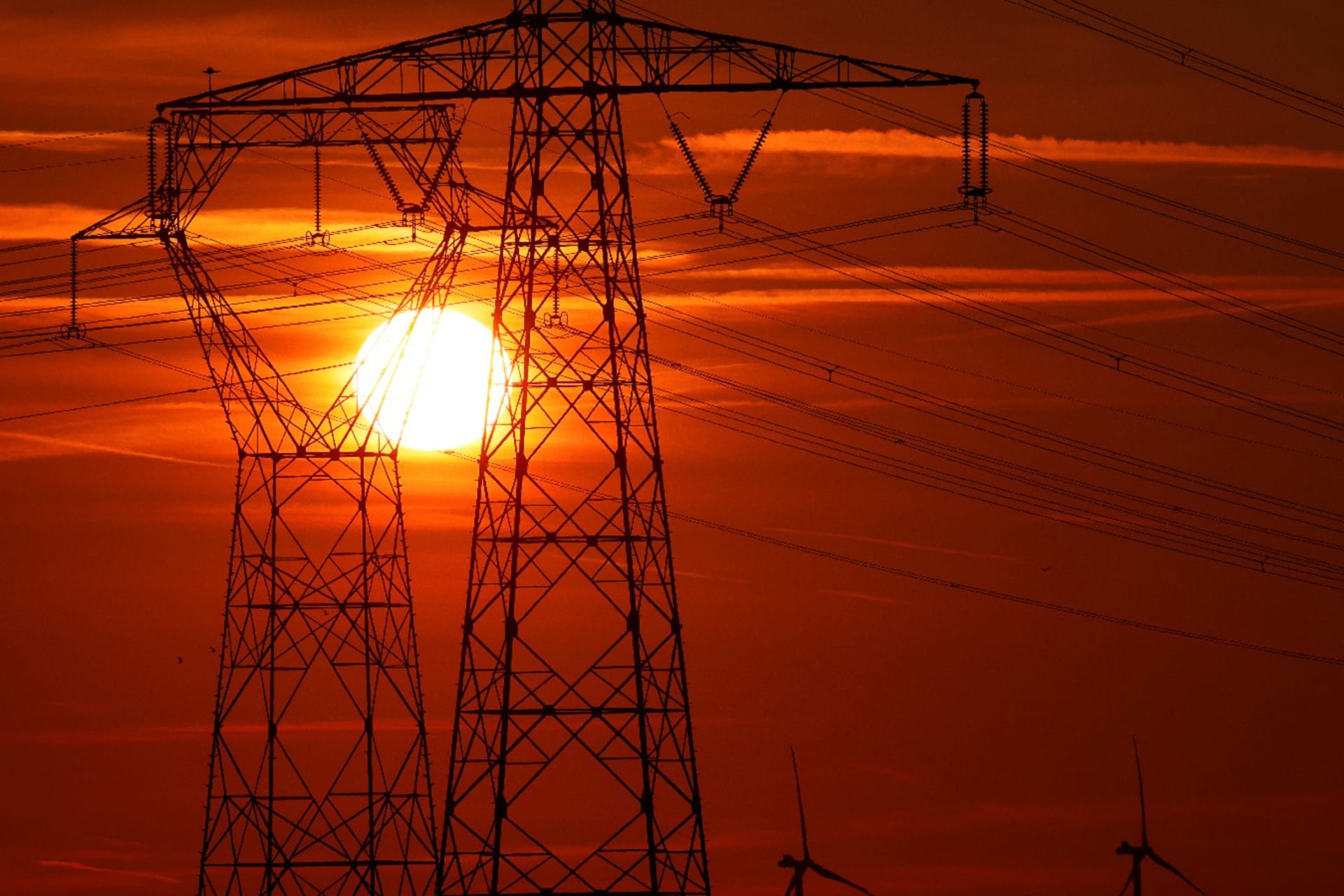 Electricity power lines and power-generating windmill turbines operate in Avesnes-le-Sec, France