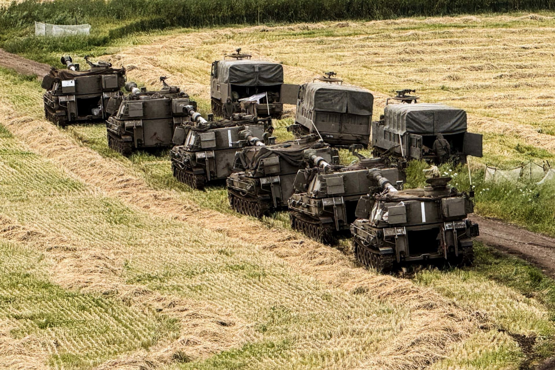 Israeli artillery units and military vehicles in formation on the Israeli side of the Israel-Lebanon border in northern Israel
