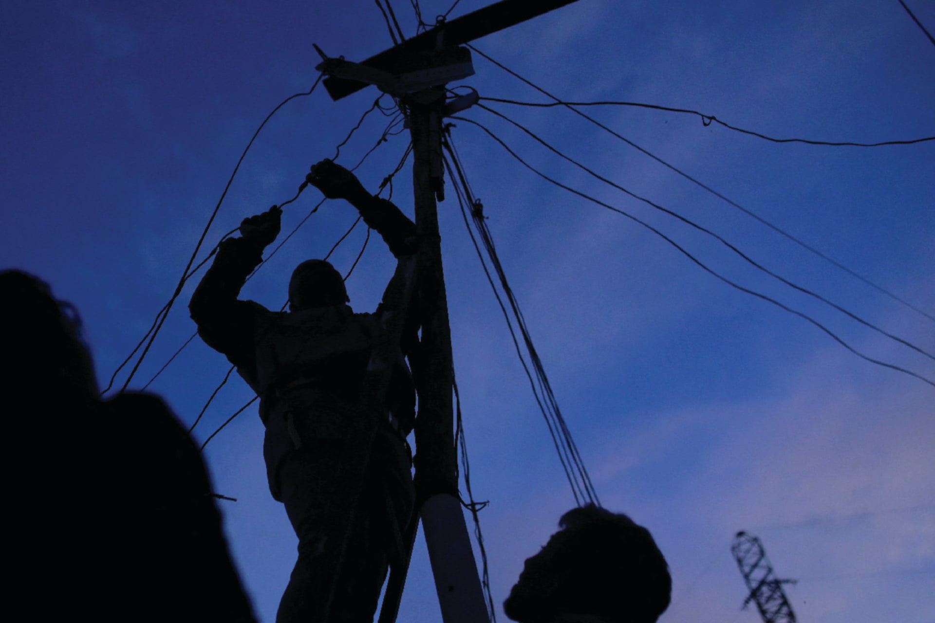 A man connects power cables during a power outage in Caracas, Venezuela on August 30, 2024.