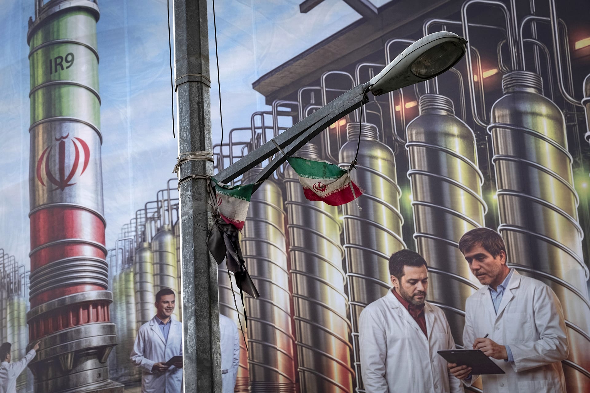 A giant banner featuring symbolic images of the Natanz nuclear enrichment facility, Iranian nuclear scientists killed in Israeli attacks during the 12-day war, and a Persian script that reads, ''Science is power,'' hangs from a governmental building in downtown Tehran, Iran, on August 28, 2025.