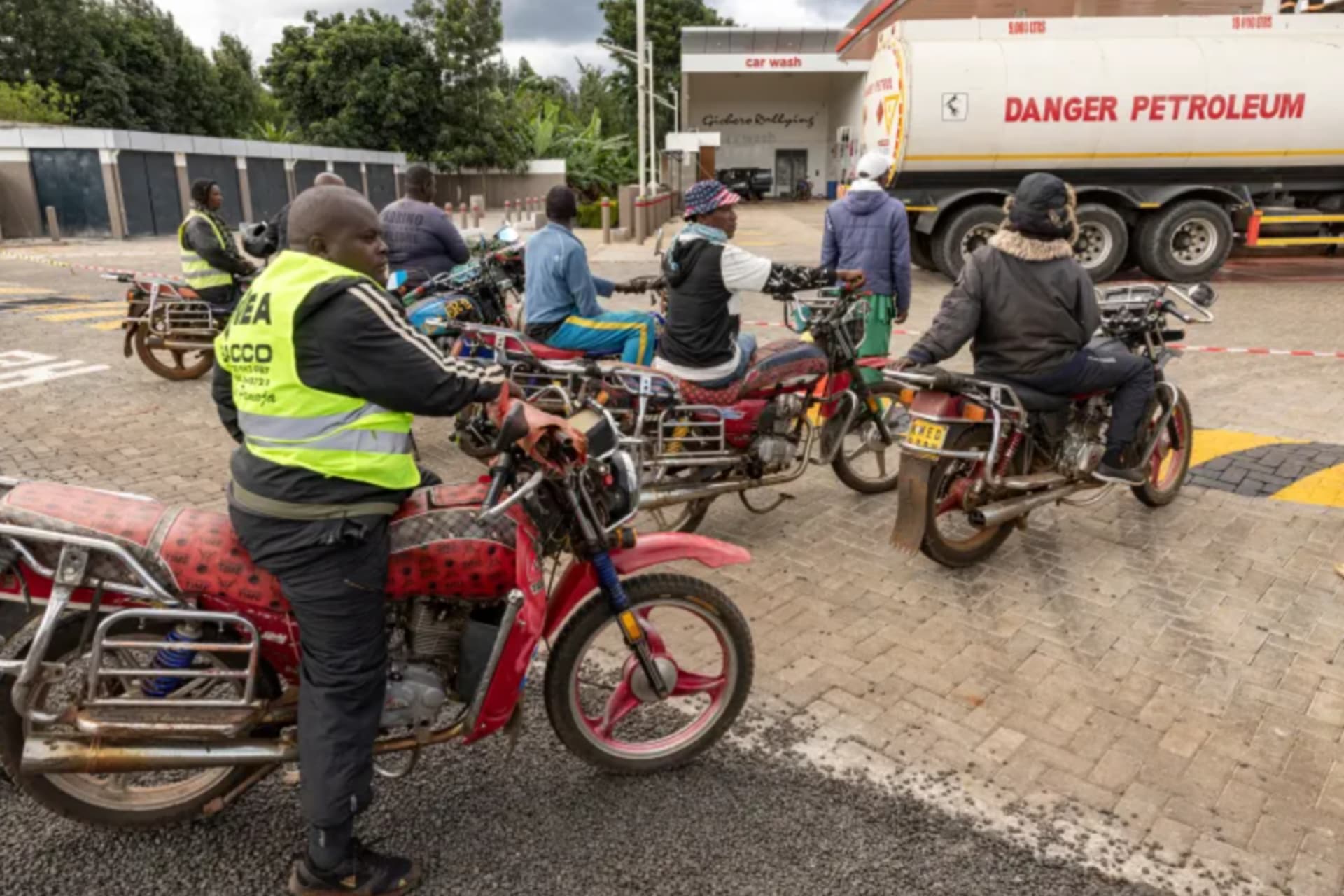 <p>Motorcycle taxi drivers queue to refuel at a petrol station in Karatina, Kenya.</p>
