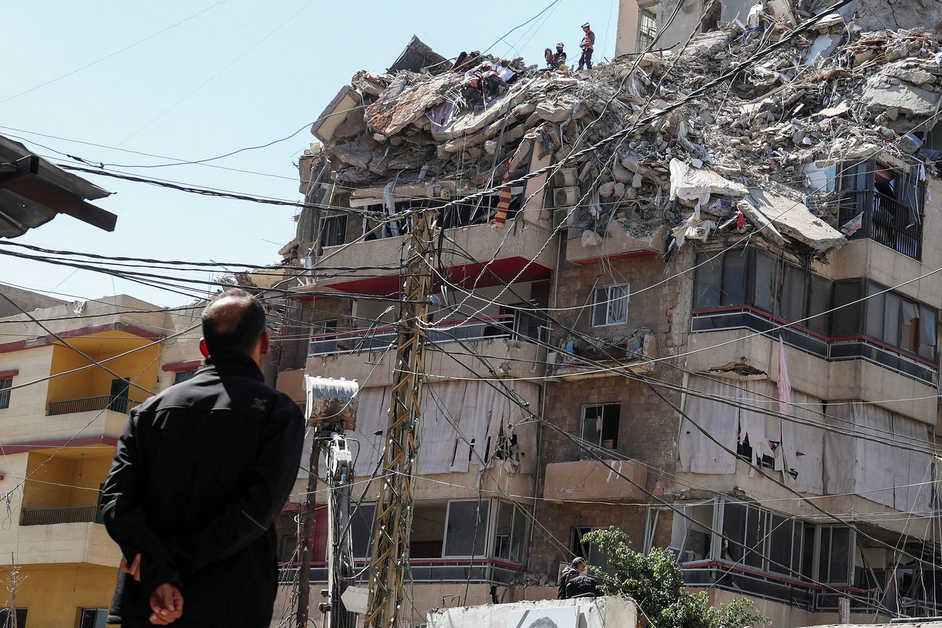 <p>A man watches as rescuers work at the site of an Israeli strike that took place yesterday, in the southern suburbs of Beirut, Lebanon, May 7, 2026. </p>
