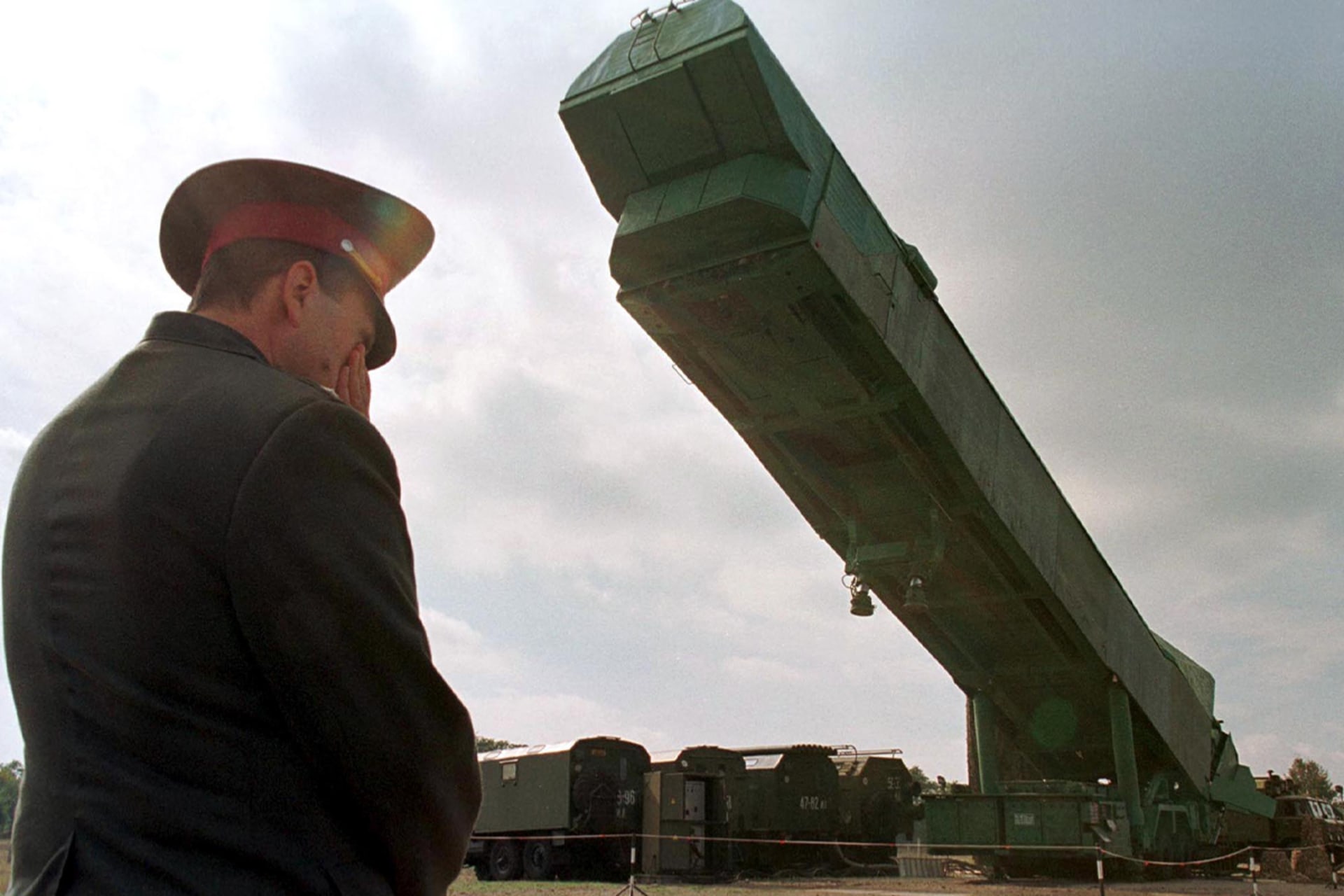 <p>A Ukrainian officer watches a nuclear missile booster being extracted from its bunker at a military base in Pervomaisk, Ukraine in 1998.</p>