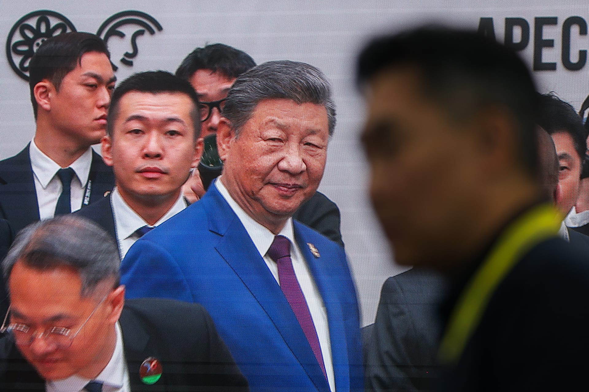 Chinese President Xi Jinping is seen greeting world leaders on a broadcast screen, as they meet during the APEC Economic Leaders' Week, in Gyeongju, South Korea, on November 1, 2025.