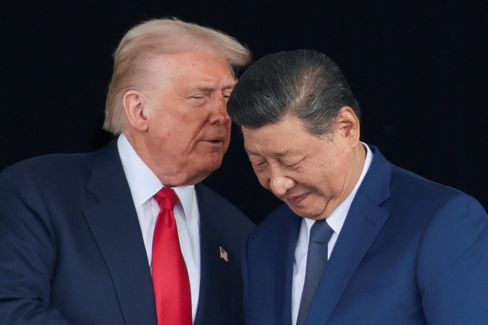 U.S. President Donald Trump and Chinese President Xi Jinping talk as they leave after a bilateral meeting at Gimhae International Airport, on the sidelines of the Asia-Pacific Economic Cooperation (APEC) summit, in Busan, South Korea, October 30, 2025.