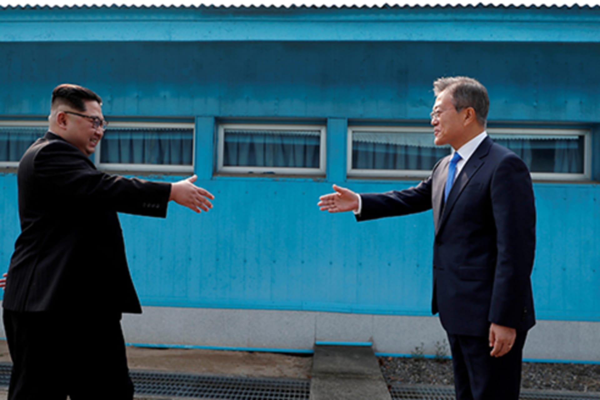 The Presidents of North and South Korea shaking hands in the DMZ.