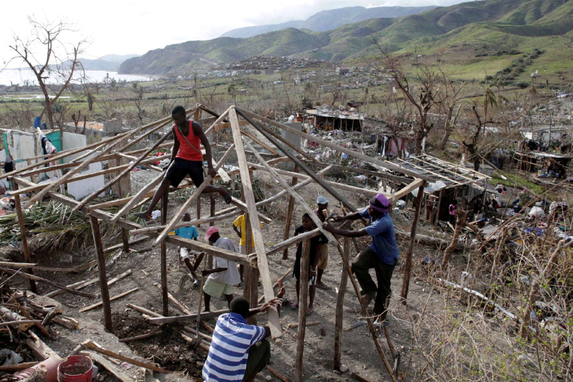 People work to rebuild a house destroyed by Hurricane Matthew in Les Anglais, Haiti on October 11, 2016.
