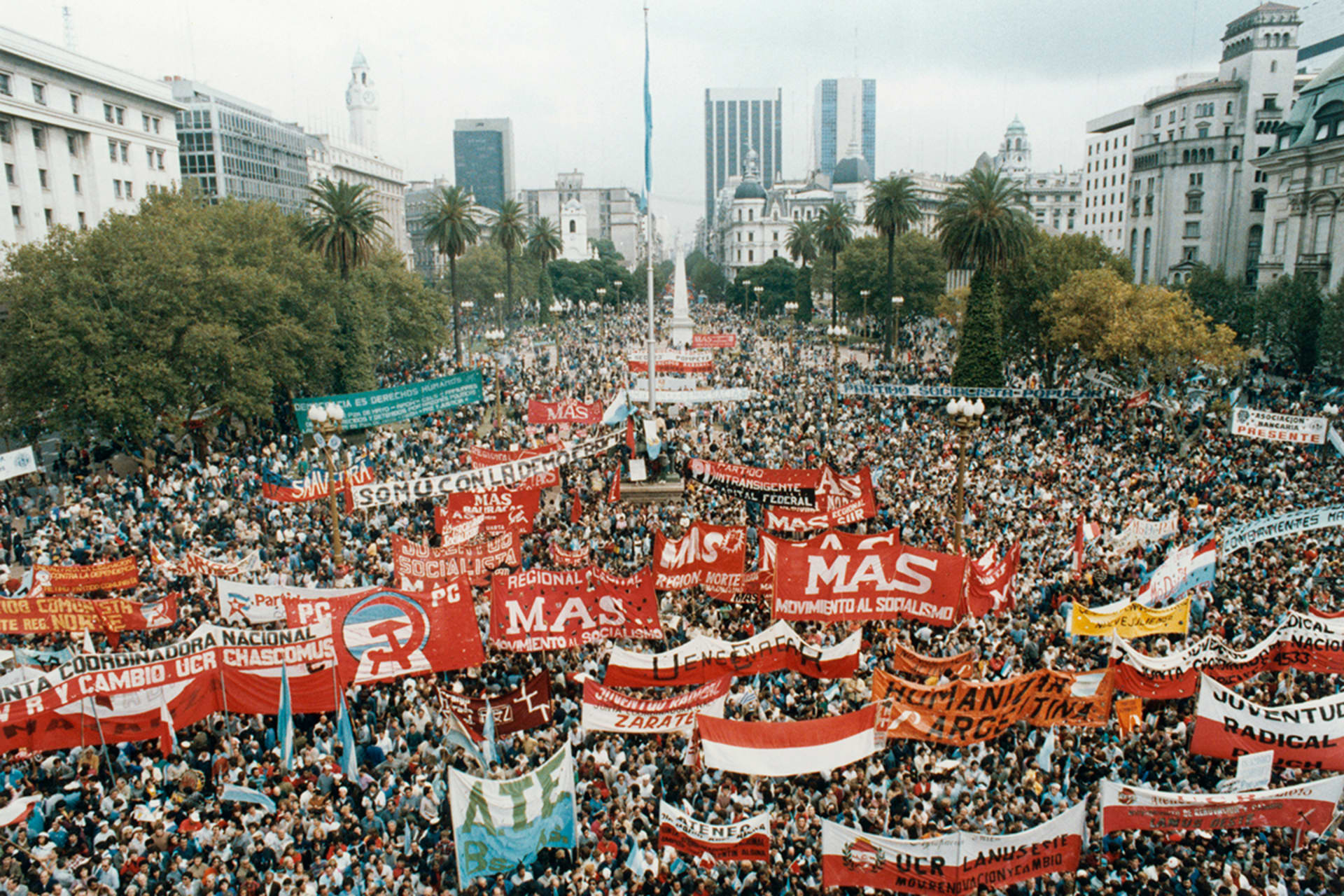 A large crowd of supporters gather in front of Argentina's presidential office to express support for the democratic government. Many signs read "MAS movimiento al socialismo"