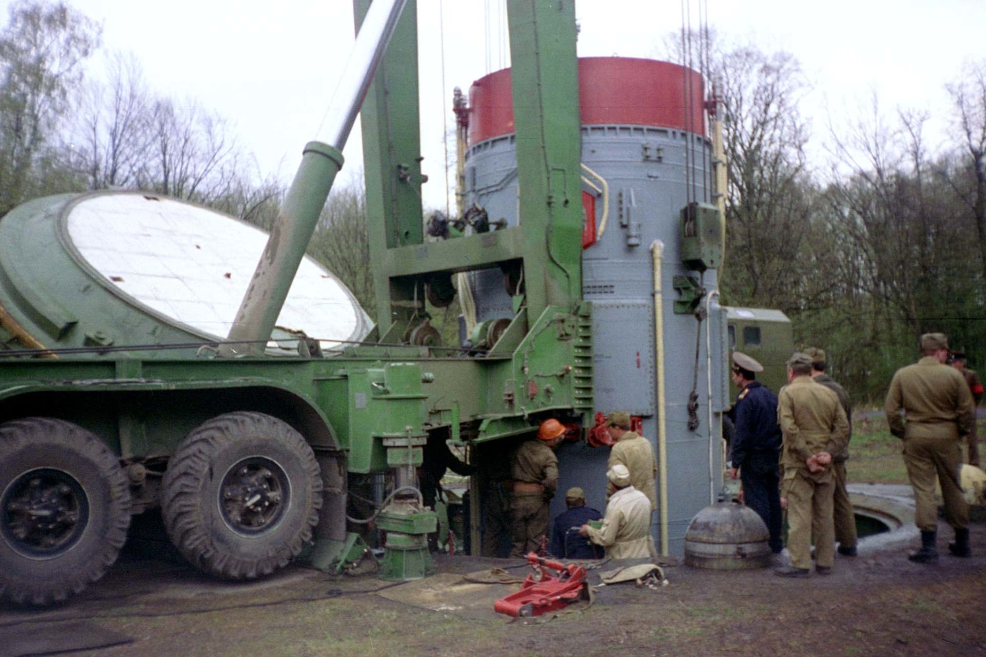 Workers remove warhead of the Soviet era SS-19 nuclear missile from the mine at a amilitary base near the Ukrainian town of Khmelnitsky as they prepare it to ship to Russia.