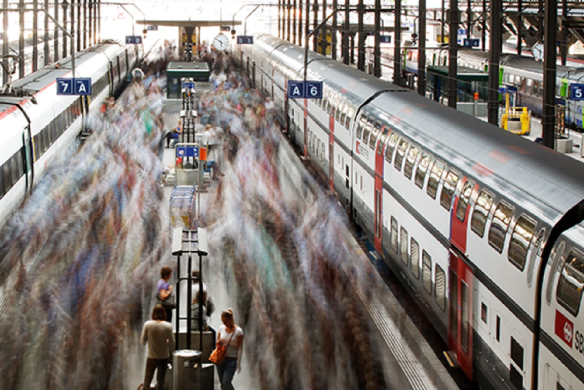 A long exposure picture shows commuters walking on a Swiss Federal Railways platform at the main station in Lucerne on August 7, 2012.
