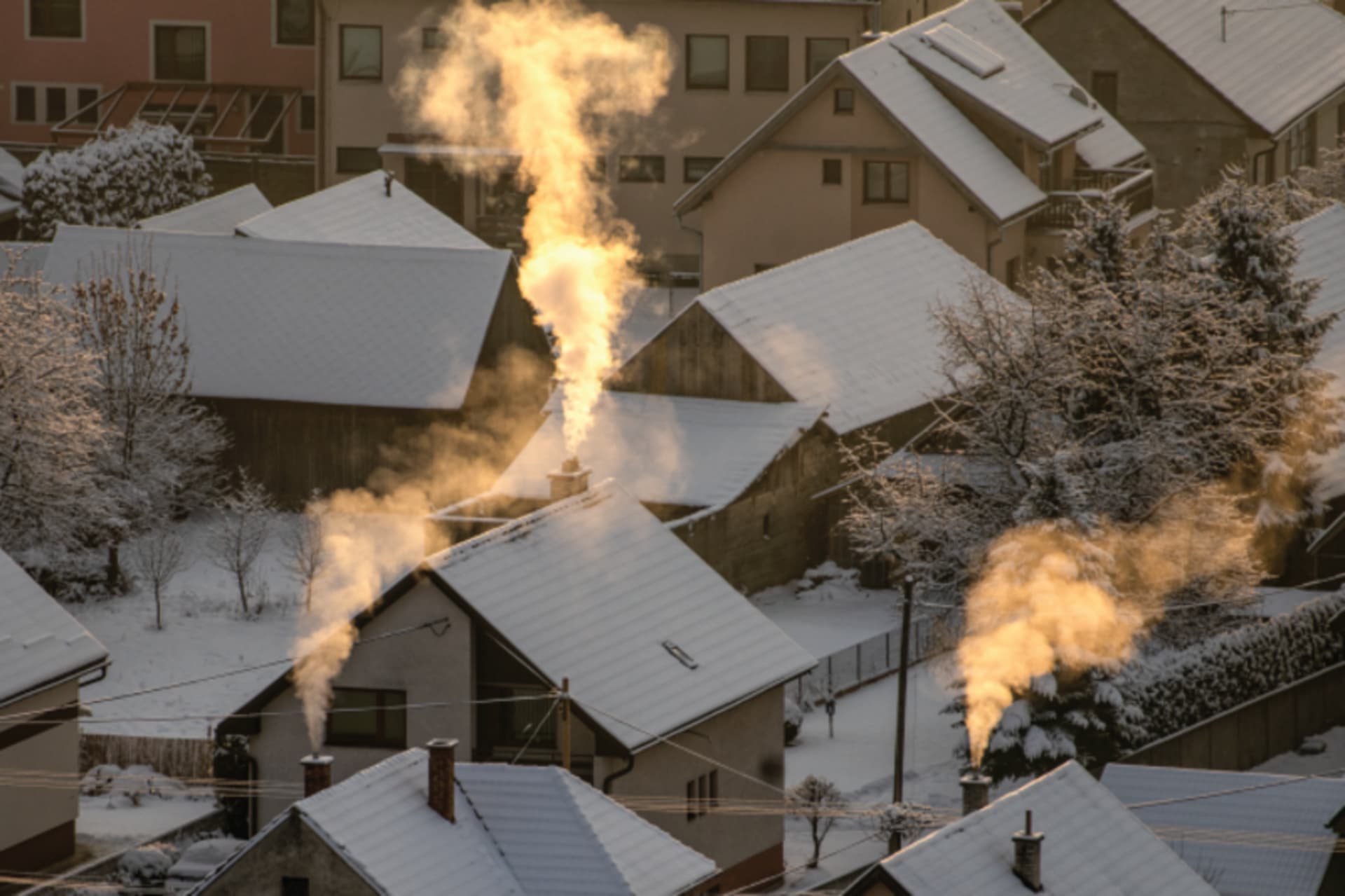 Houses with smoke coming out of the chimney in Winter