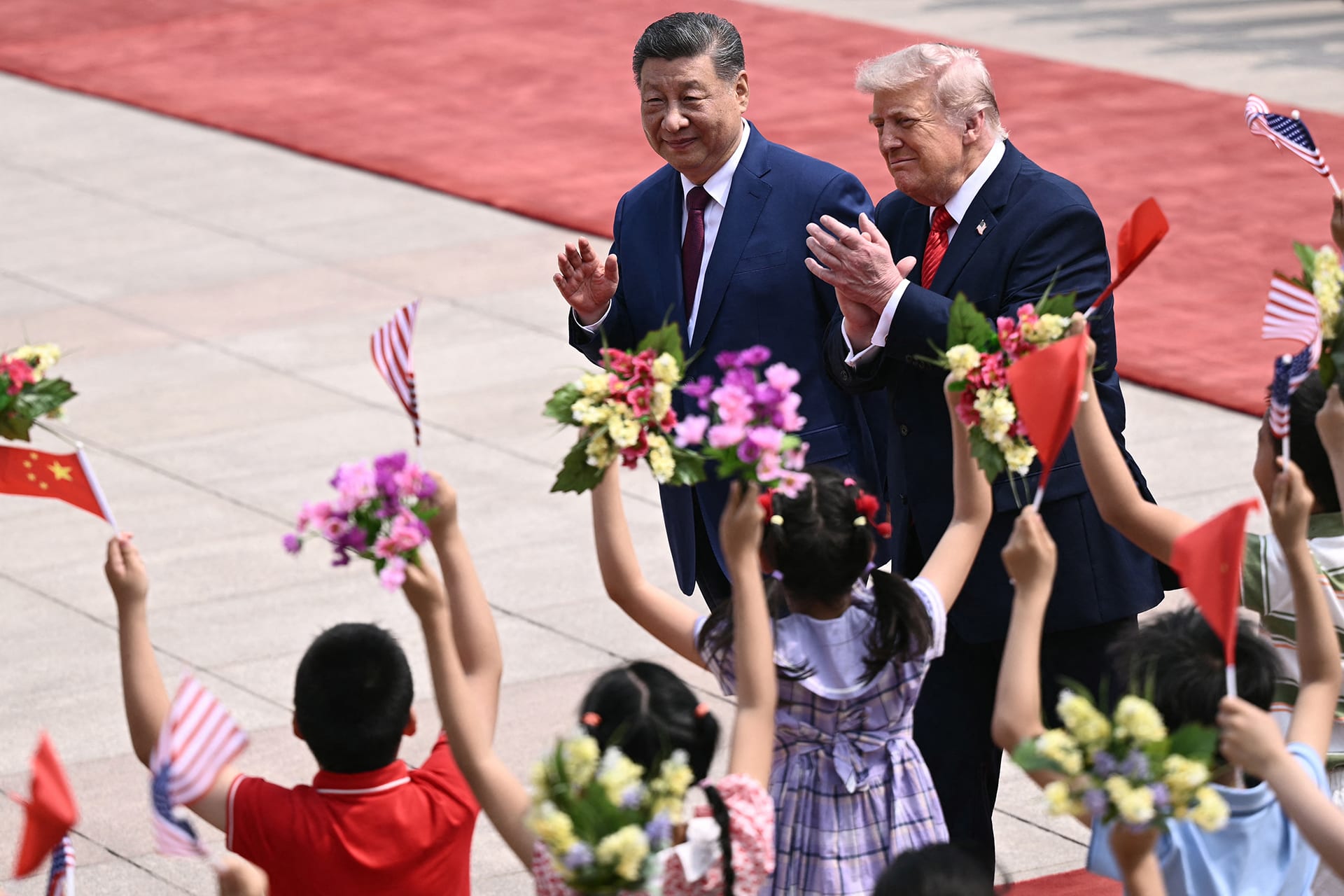 <p>US President Donald Trump (R) and China’s President Xi Jinping (L) during a welcome ceremony at the Great Hall of the People in Beijing on May 14, 2026. </p>
